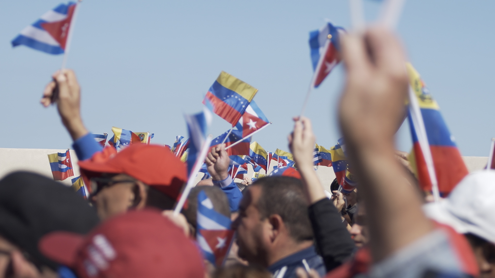 Protesters wave Venezuelan and Cuban flags