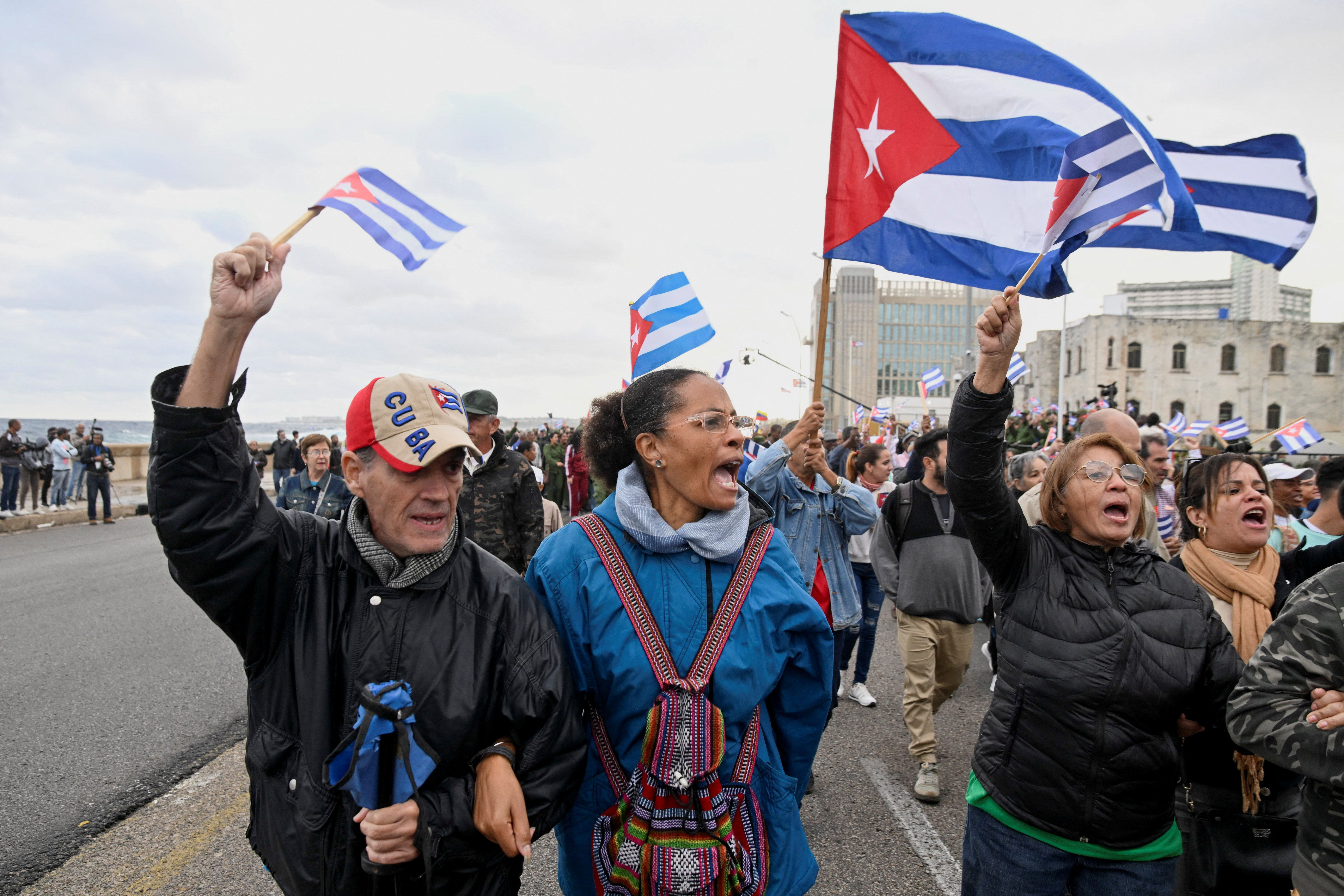 People wave Cuban flags during a march outside the U.S. Embassy to protest what demonstrators denounce as U.S. aggression in the region, following the capture of Venezuelan leader Nicolas Maduro and his wife, Cilia Flores, and the killing of Cuban soldiers in a U.S. strike, in Havana, Cuba, January 16, 2026. REUTERS/Norlys Perez