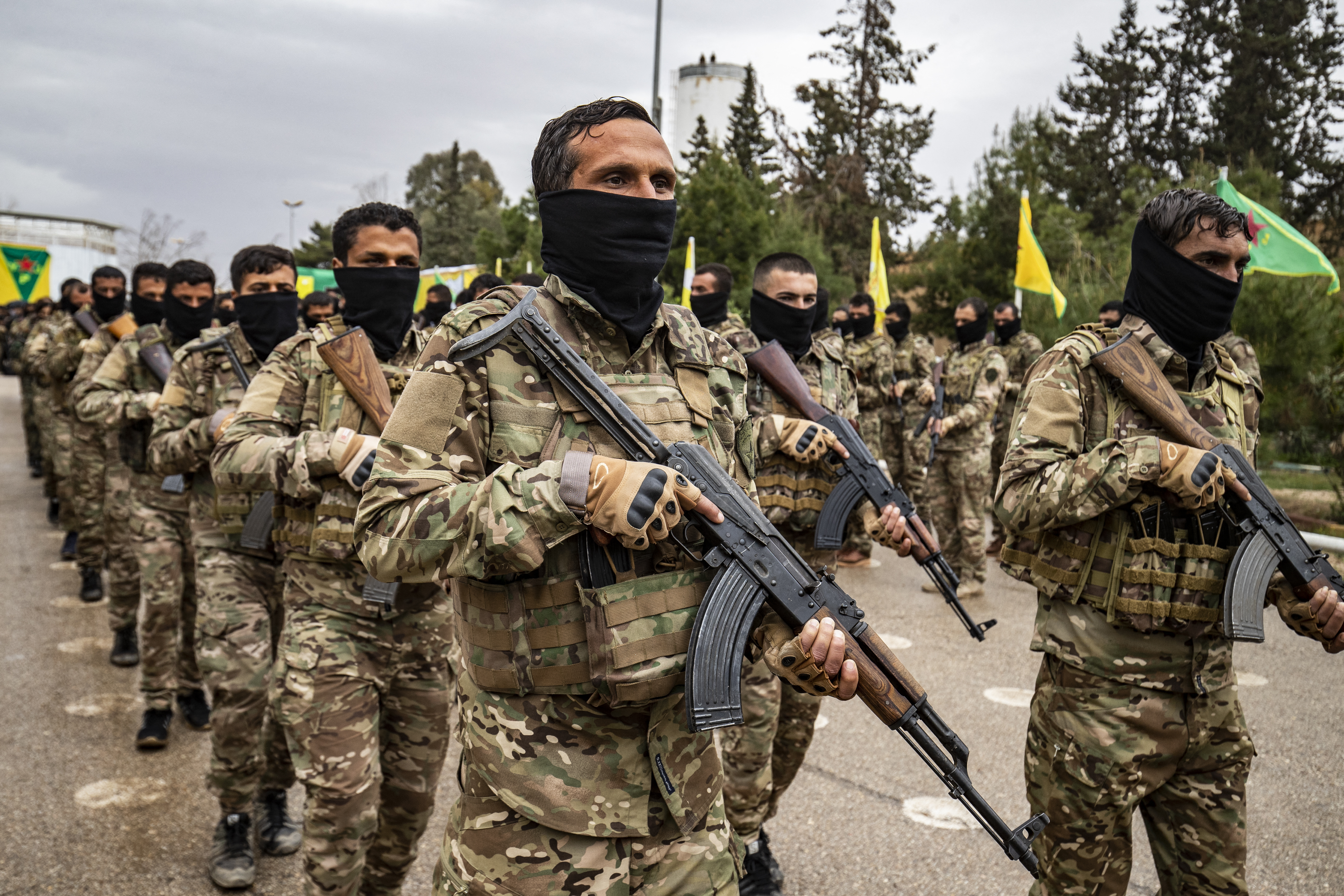Syrian Democratic Forces fighters take part in a military parade