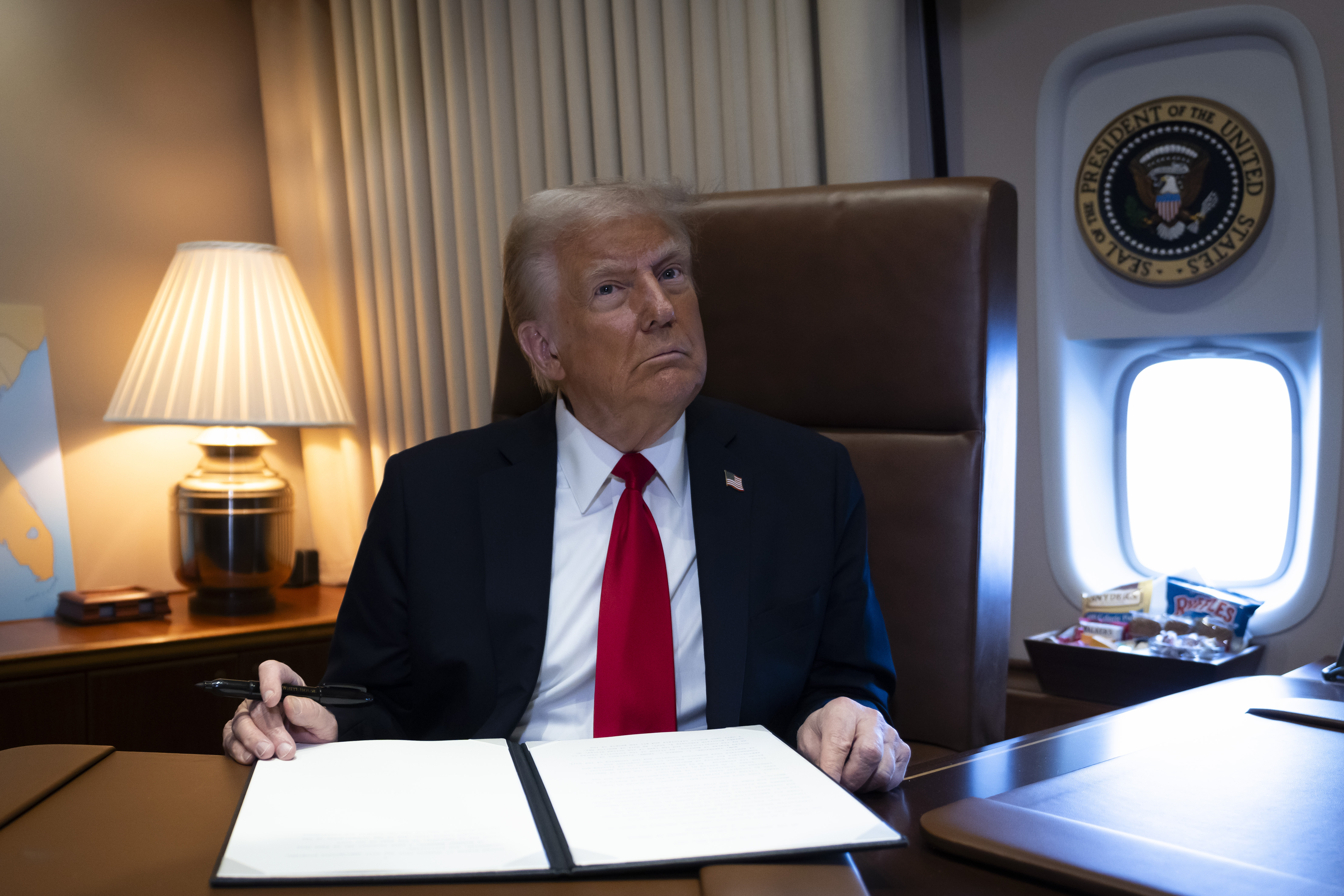 Trump signs an executive order in Air Force One