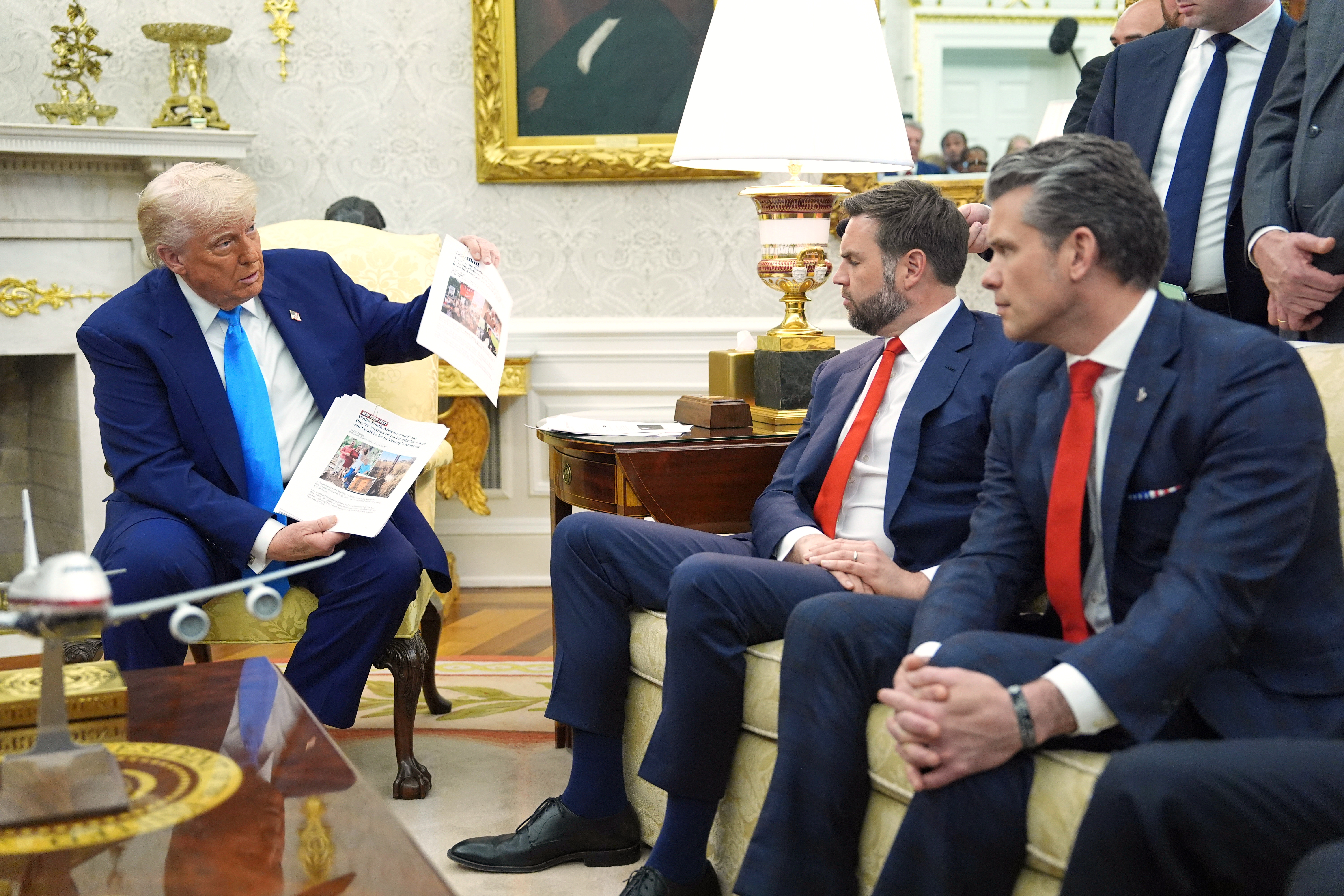 Trump shows documents that purport to show South African discrimination against Afrikaners.