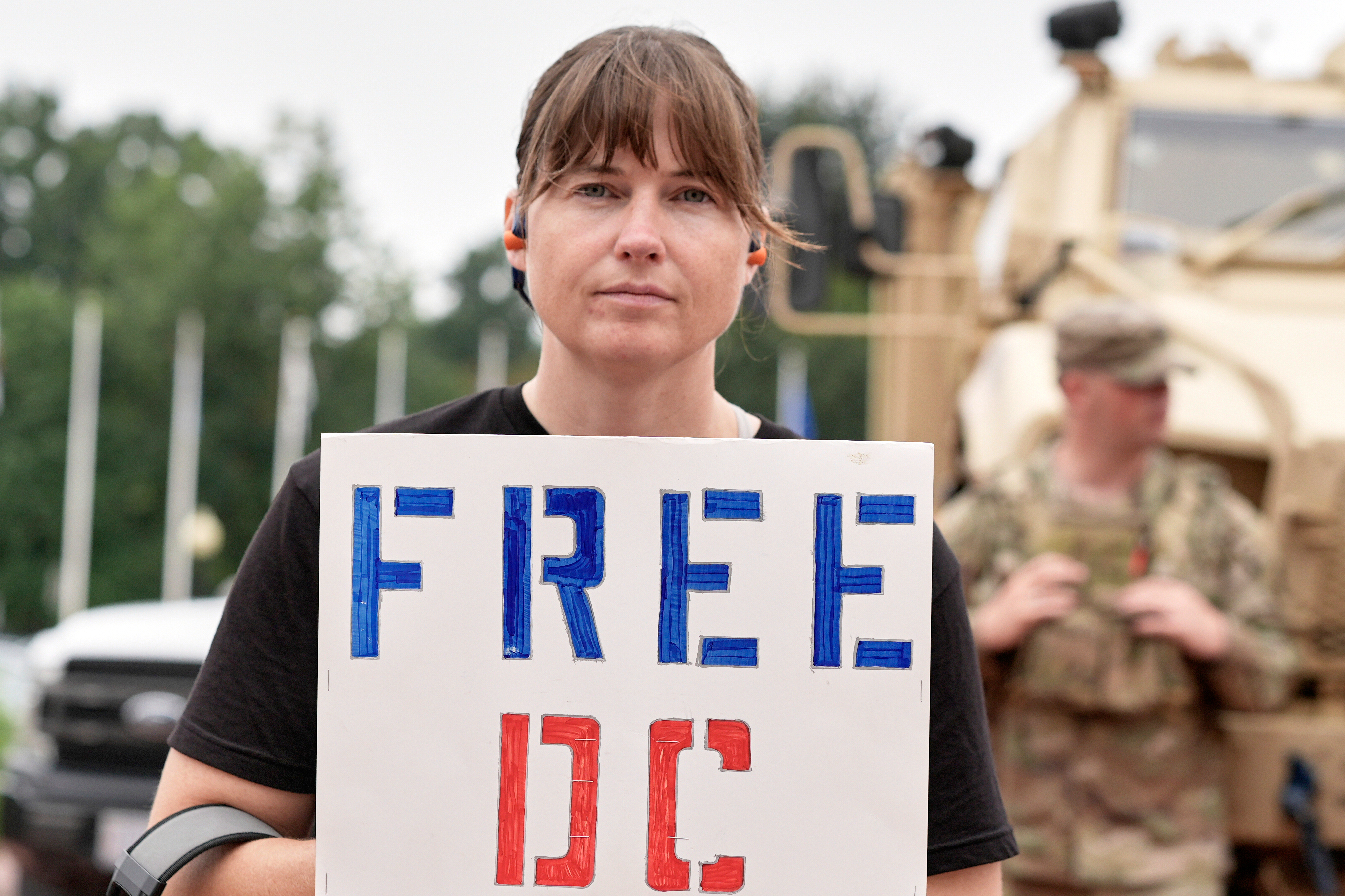 A demonstrator holds a sign that reads, "Free DC"