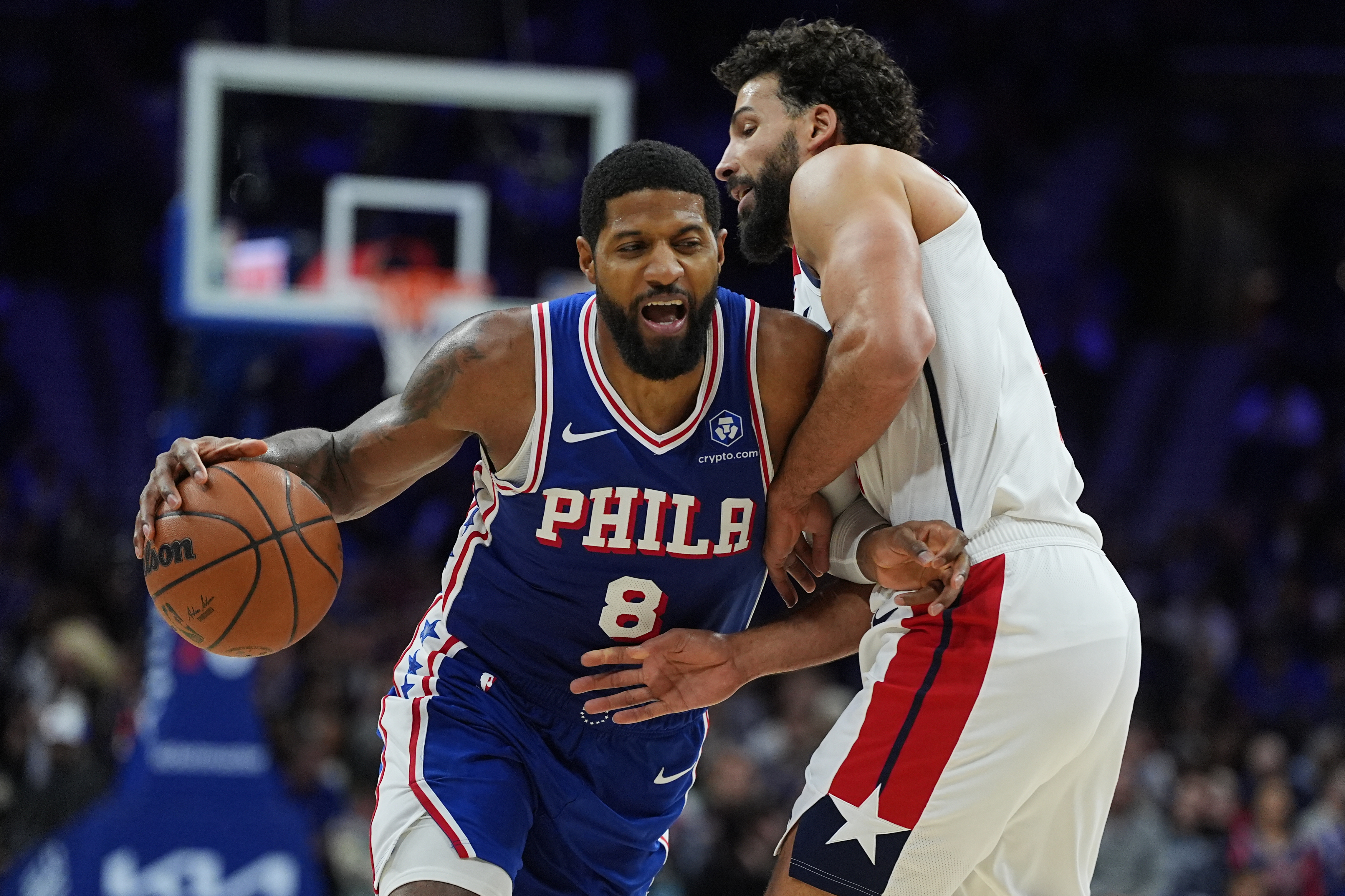 Philadelphia 76ers' Paul George (8) tries to get a shot past Washington Wizards' Anthony Gill during the second half of an NBA basketball game Wednesday, Jan. 7