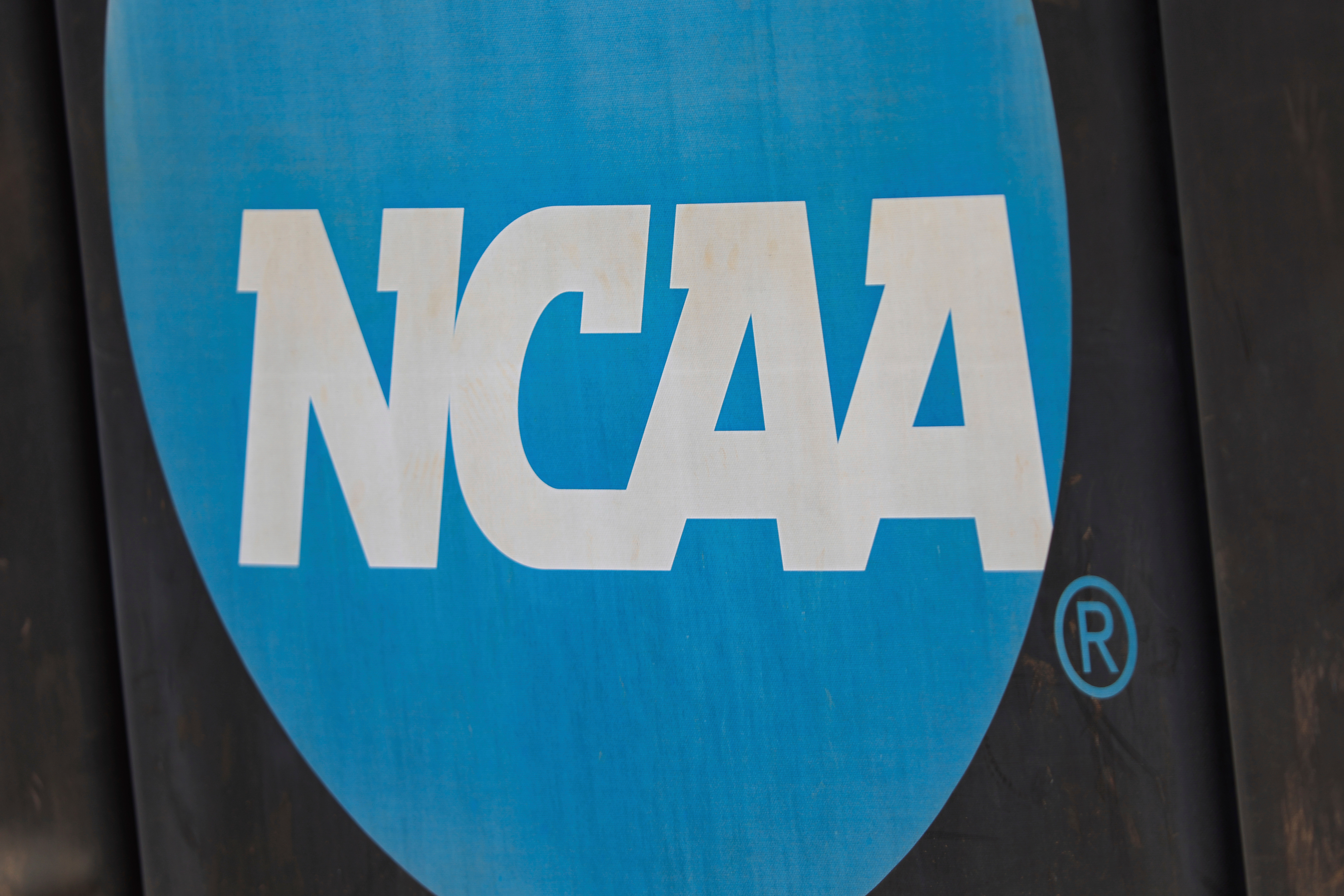 NCAA logo displayed on the fence before an NCAA softball game between Jacksonville and FGCU,