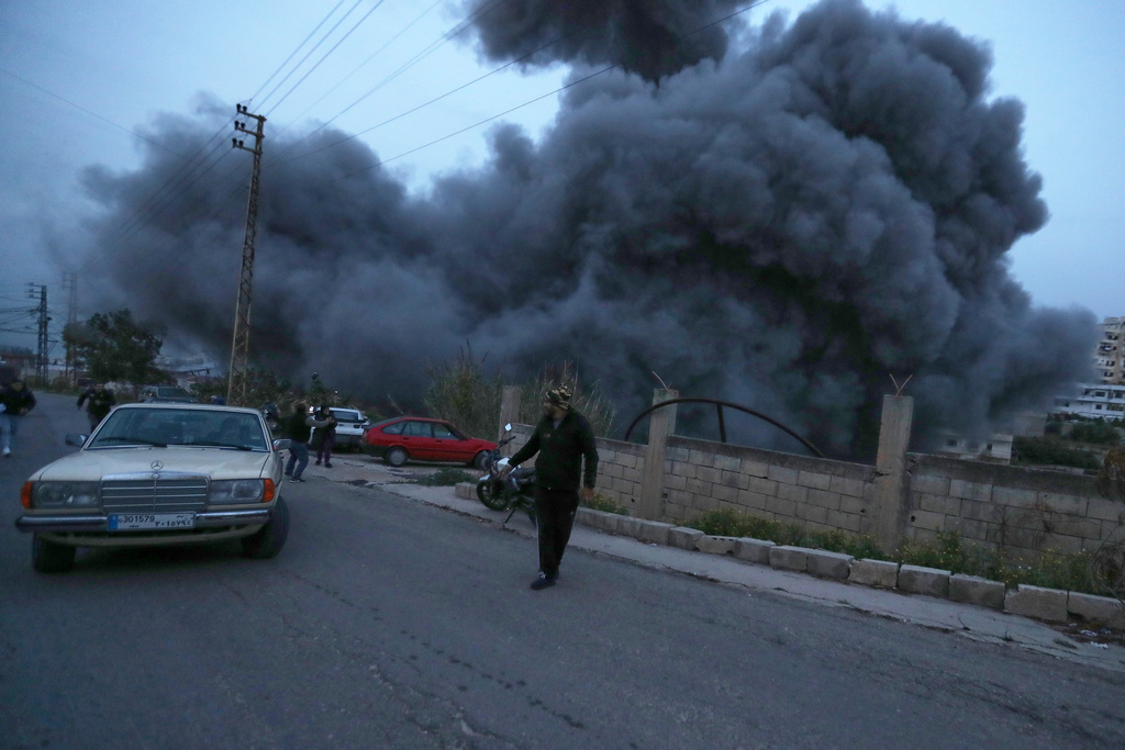 Man stands in front of rising smoke
