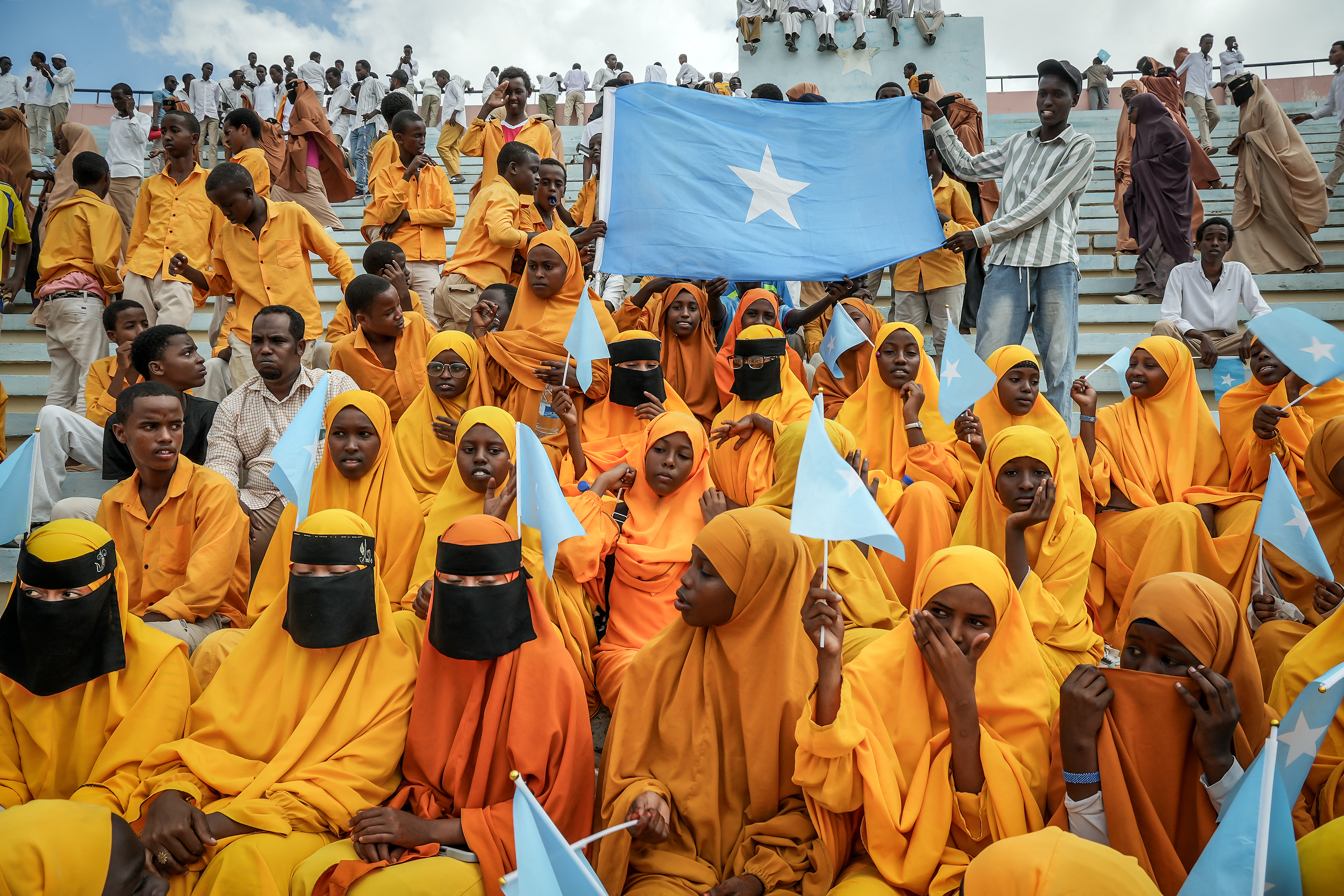 (FILES) Residents wave Somali flags as they attend a rally denouncing Israel’s recent announcement recognizing the breakaway Somaliland region, during a gathering calling for Somalia’s territorial unity at Mogadishu Stadium in Mogadishu on December 30, 2025.