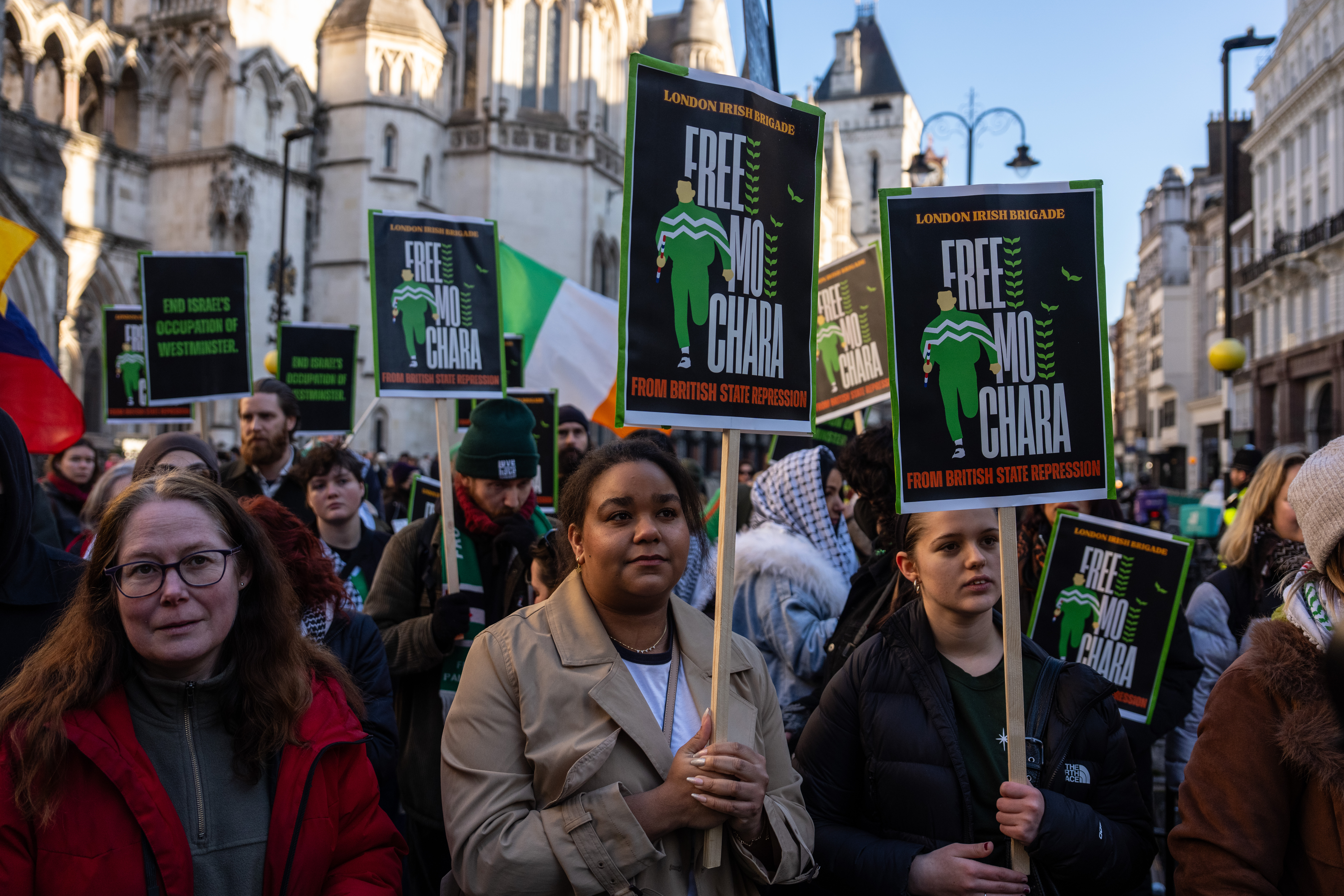 LONDON, ENGLAND - JANUARY 14: Protesters gather outside the High Court on January 14, 2026 in London, England. The appeal against the decision to throw out the terrorism case against Mo Chara (real name Liam Óg Ó hAnnaidh) is being heard in the High Court. The Kneecap rapper was reportedly seen wearing a flag of the proscribed terrorist organization, Hezbollah. (Photo by Carl Court/Getty Images)