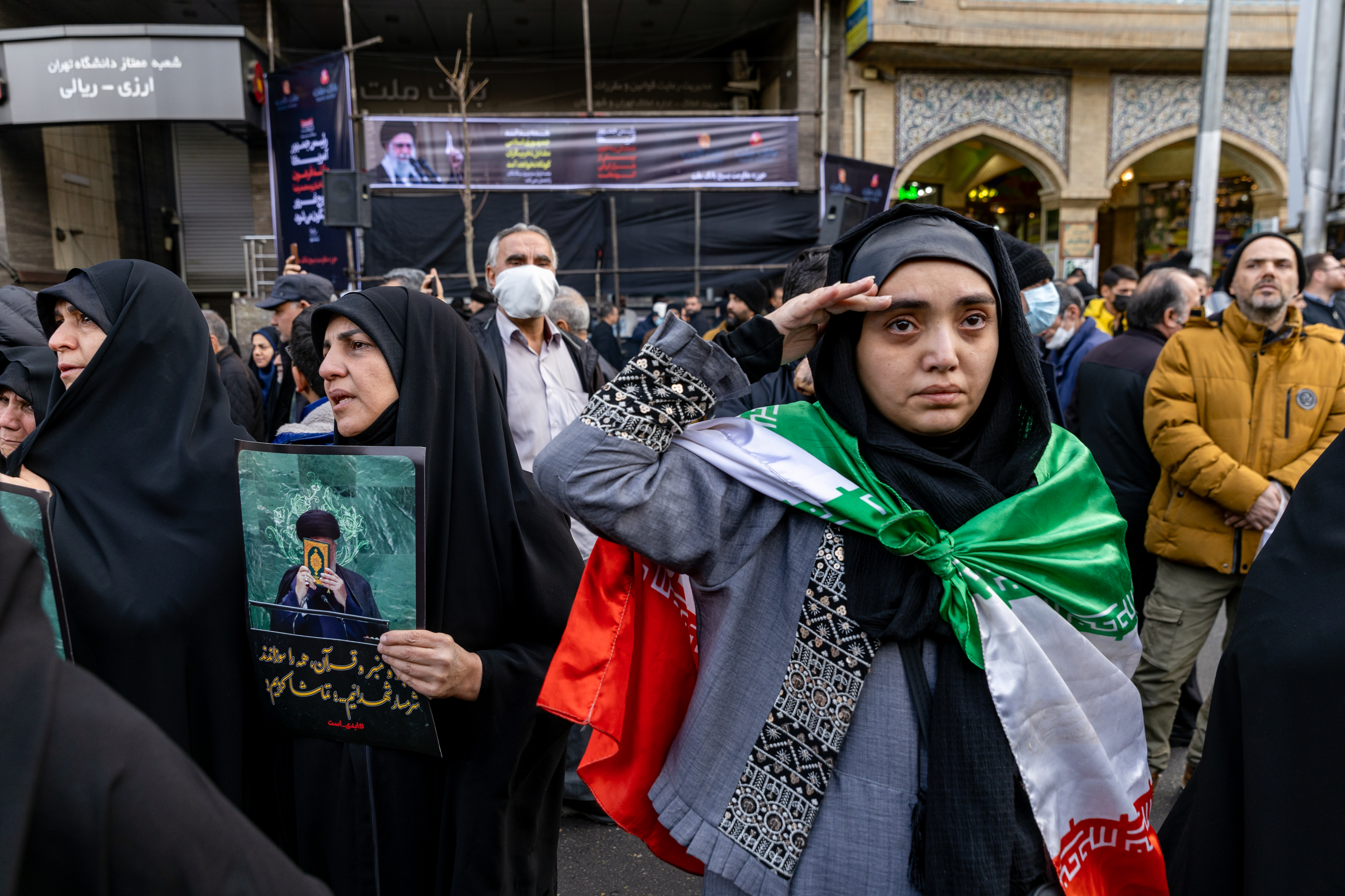 TEHRAN, IRAN - JANUARY 14: A woman in the crown gestures during a mass funeral held for over 100 members of the security forces whom authorities said were killed during recent nationwide protests, on January 14, 2026 outside Tehran University in Tehran, Iran. The country has been gripped by a wave of anti-government protests and the ensuing crackdown, which rights groups say has left thousands of civilians dead. (Photo by Stringer/Getty Images)