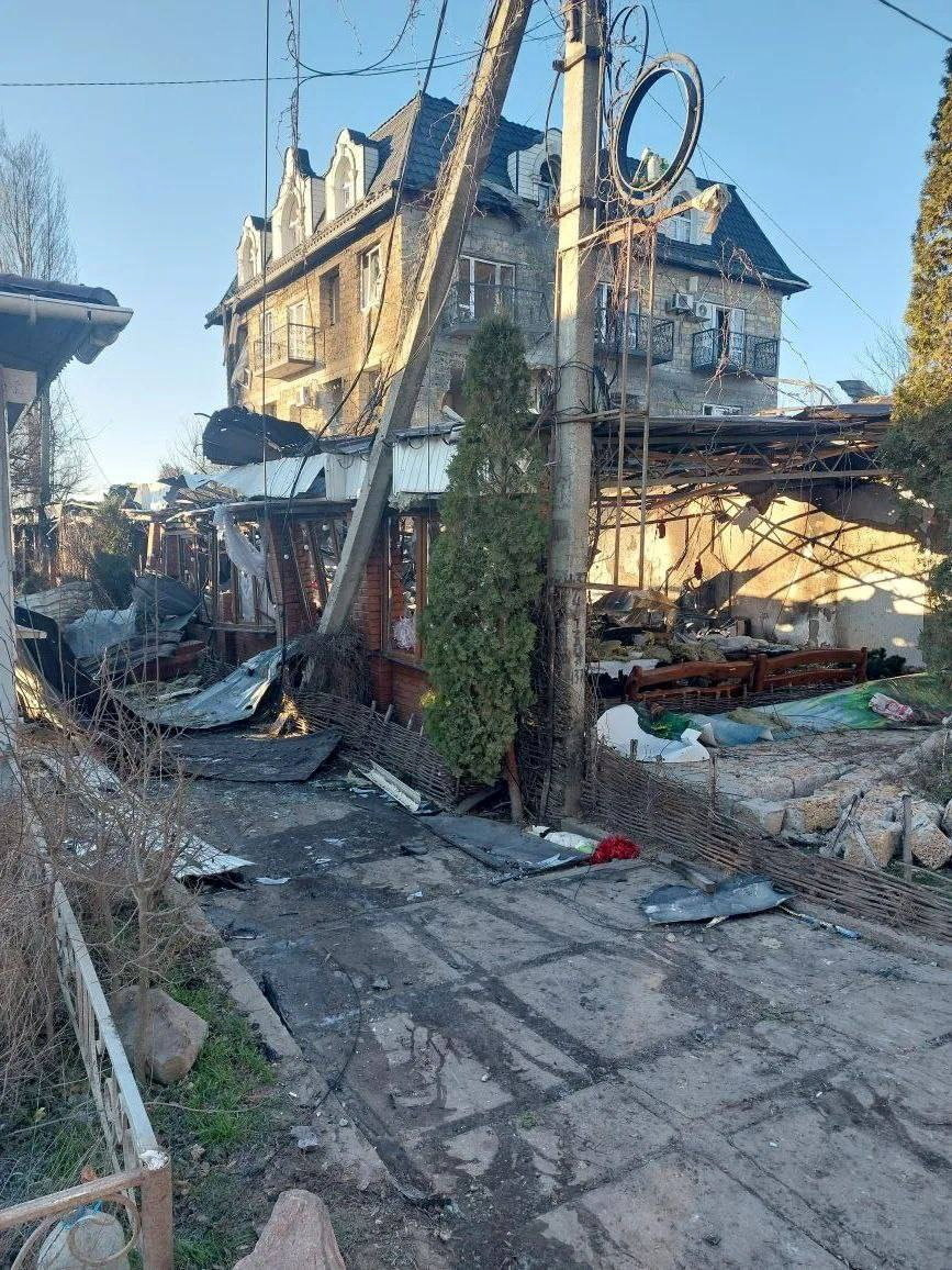 Debris lies on the ground near a destroyed building following what Russian-installed authorities described as an overnight Ukrainian drone strike on a hotel and cafe in Khorly village in the Kherson region, a Russian-controlled area of Ukraine