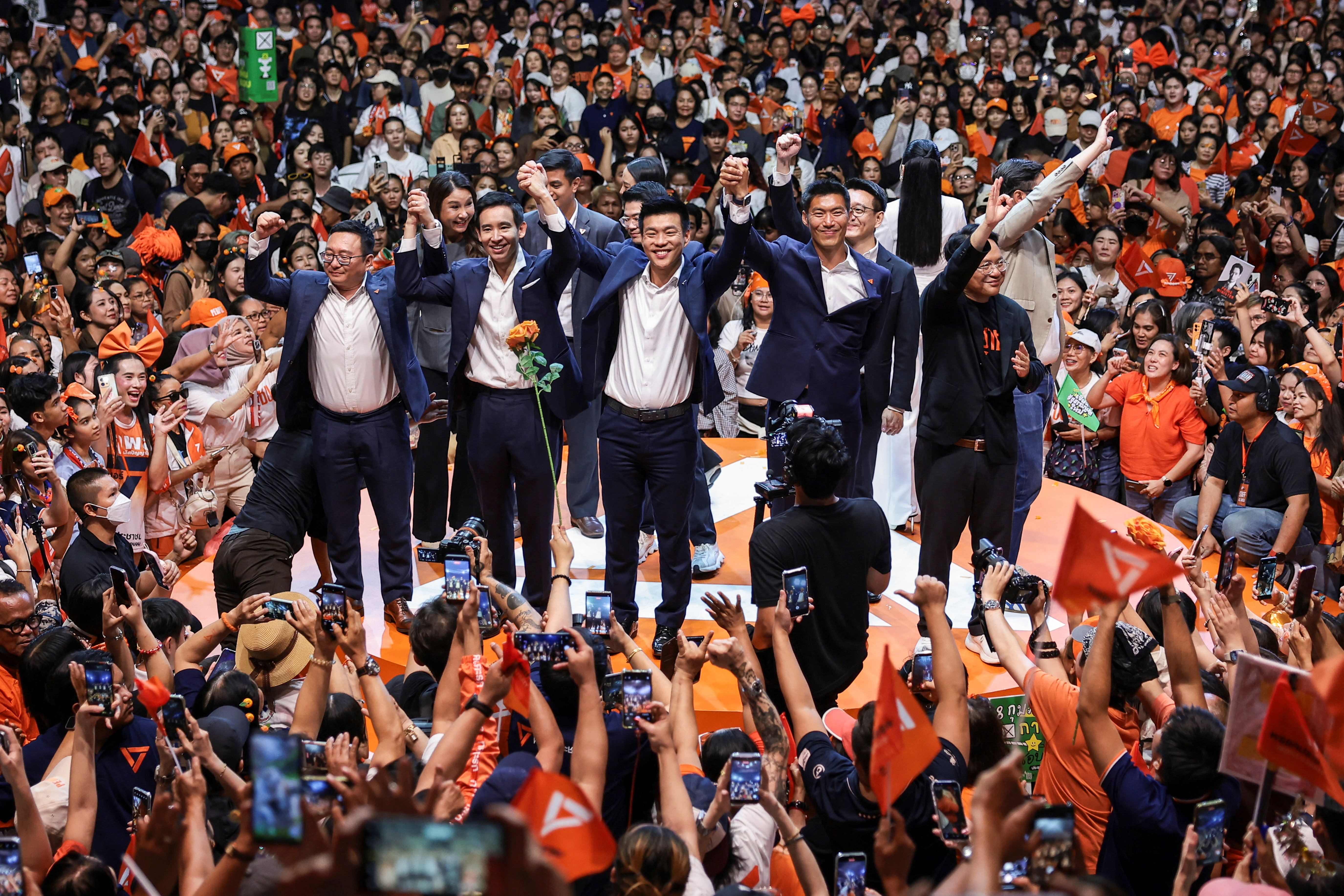 People’s Party leader and prime ministerial candidate Natthaphong Ruengpanyawut, former Future Forward Party leader Thanathorn Juangroongruangkit, former Move Forward Party leader Pita Limjaroenrat and other party members gesture during a major rally event ahead of the February 8 election in Bangkok, Thailand, February 6, 2026.