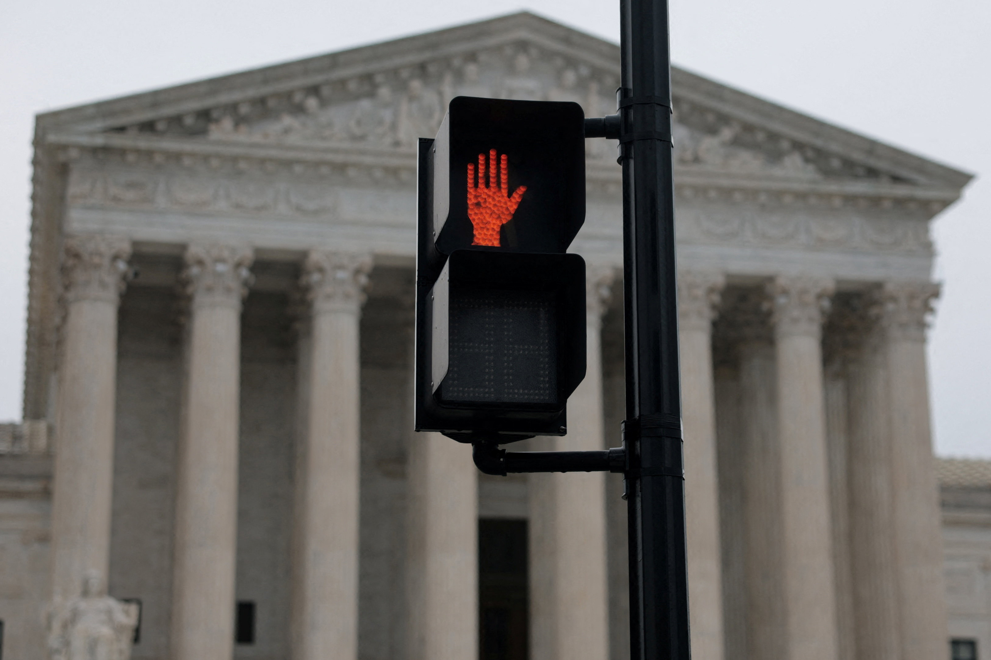 A stop light in front of the U.S. Supreme Court building