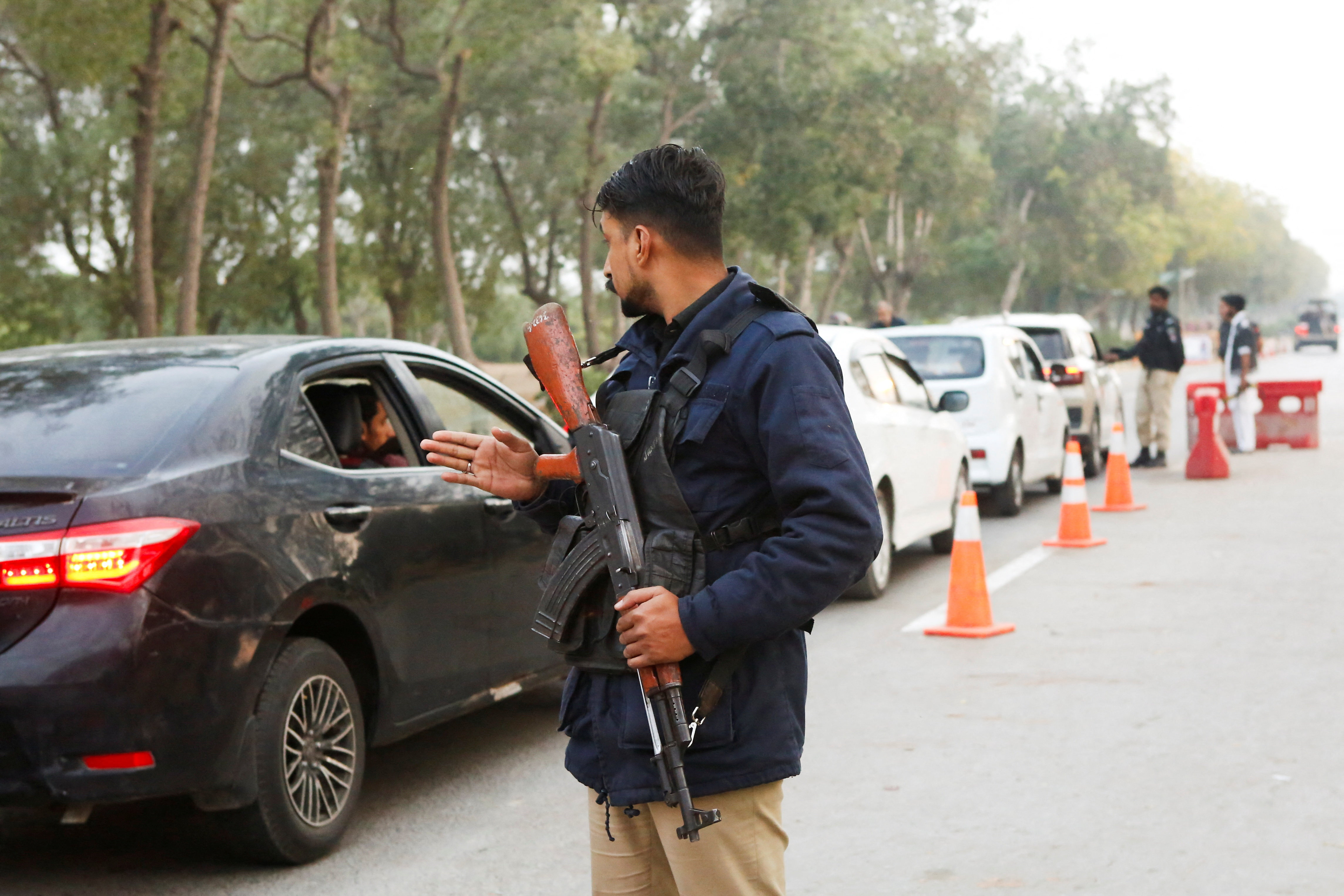 A police officer controls traffic flow as a security measure, following exchanges of fire between Pakistani and Afghan forces, along a road leading to the airport in Karachi, Pakistan, February 28, 2026. REUTERS/Asim Hafeez