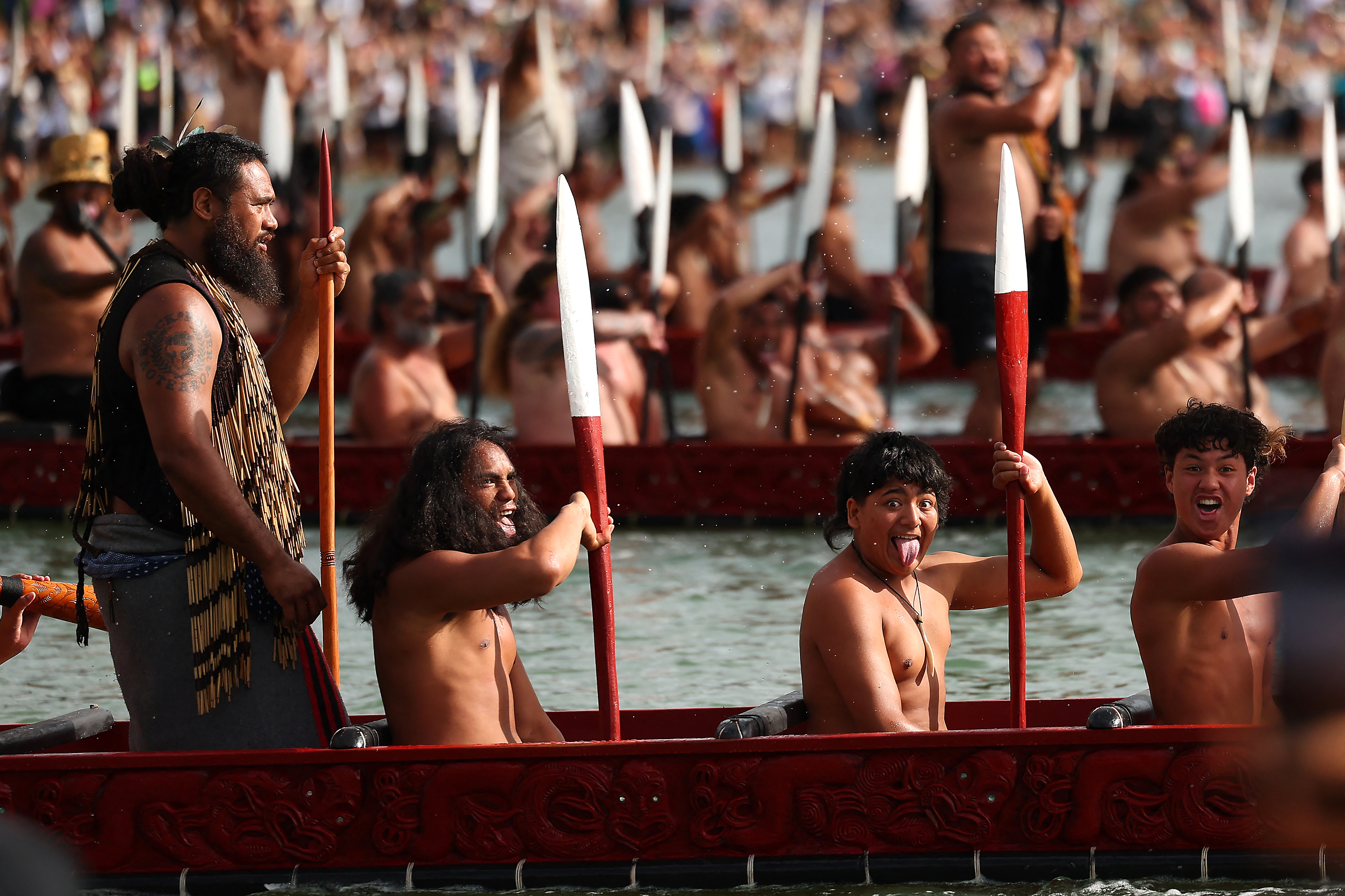 Participants paddle their boats during a waka ceremony in Waitangi on February 6, 2026, as part of Waitangi Day commemorations, an annual national event where Indigenous Maori groups highlight ongoing political concerns. (Photo by Ben STRANG / AFP)