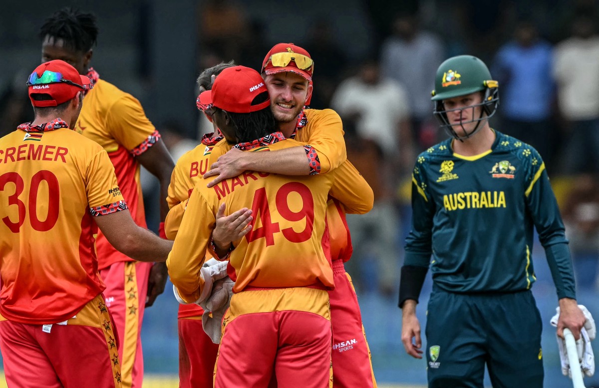 Zimbabwe's Brian Bennett (C, back) celebrates with teammates.