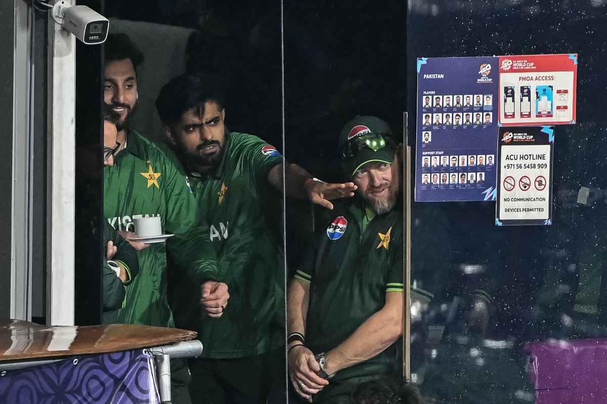 Pakistan's Babar Azam (C) and his captain Salman Agha (L) react after the 2026 ICC Men's T20 Cricket World Cup Super Eight match between Pakistan and New Zealand
