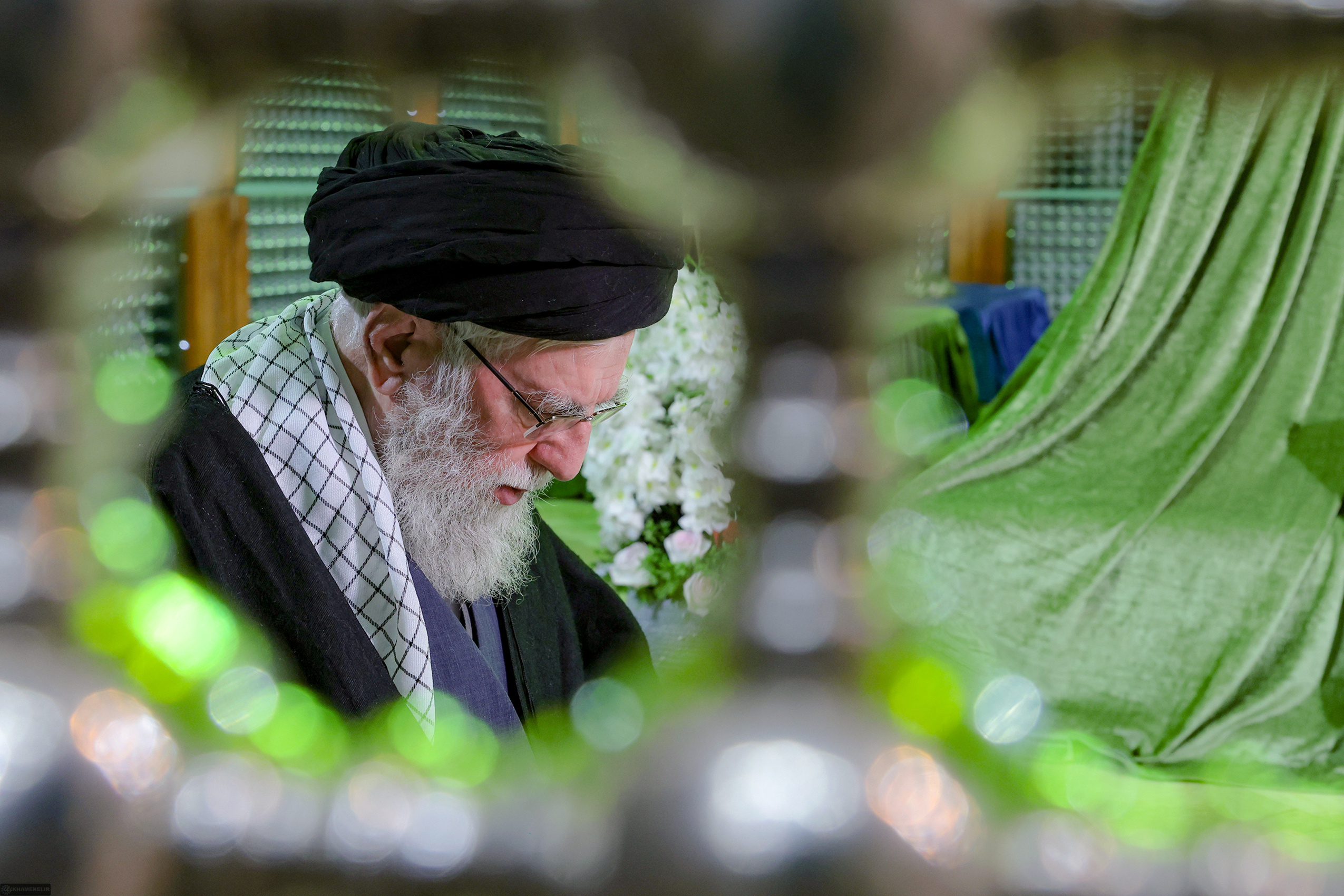 In this photo released by an official website of the office of the Iranian supreme leader, Supreme Leader Ayatollah Ali Khamenei prays at the grave of the late revolutionary founder Ayatollah Khomeini, commemorating 47th anniversary of his return from exile during 1979 Islamic Revolution, just outside Tehran, Iran, Saturday, Jan. 31, 2026. (Office of the Iranian Supreme Leader via AP)
