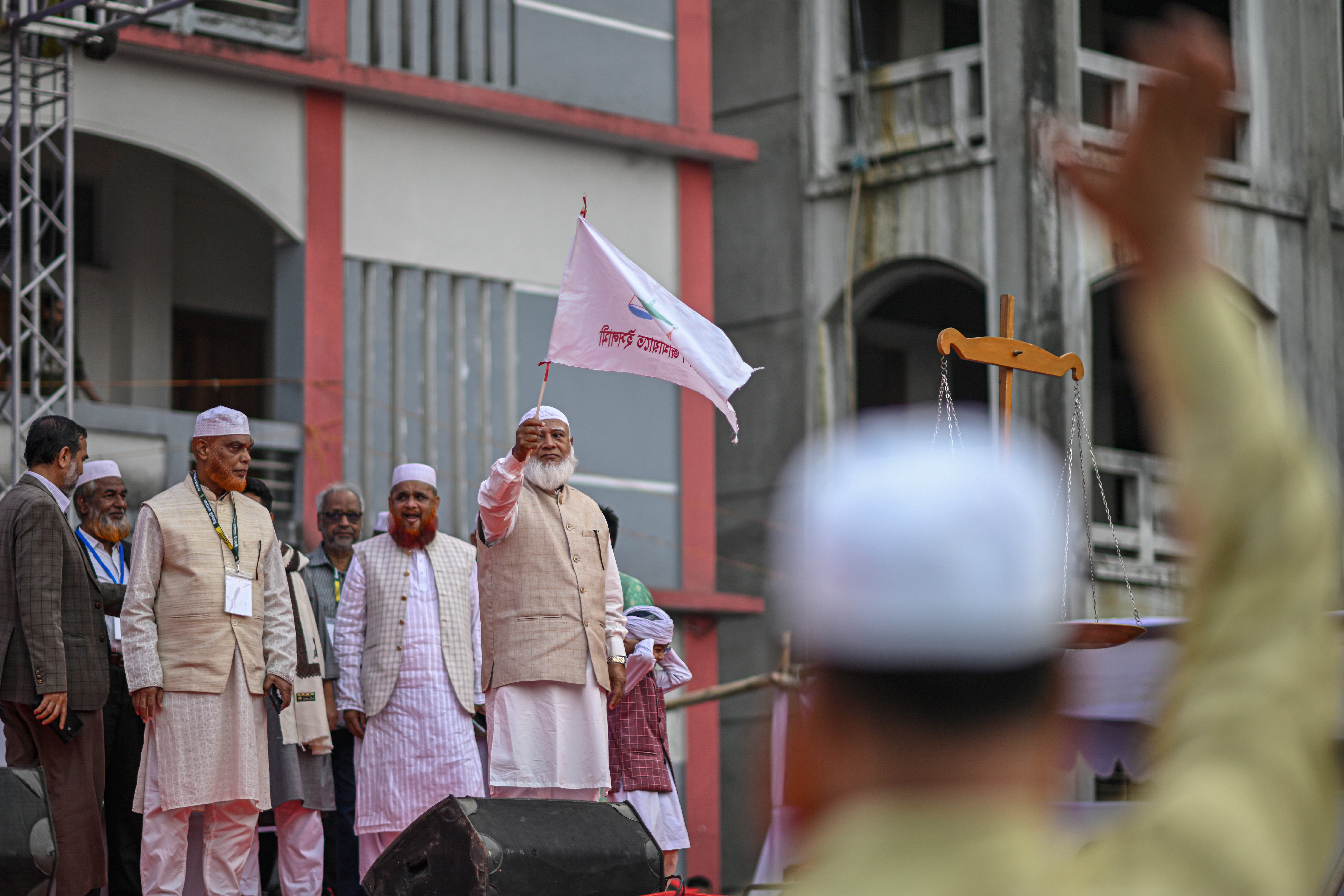 Bangladesh Jamaat-e-Islami leader Shafiqur Rahman waves a their party flag during an election campaign in Dhaka, Bangladesh, Jan. 22, 2026. (AP Photo/Mahmud Hossain Opu)