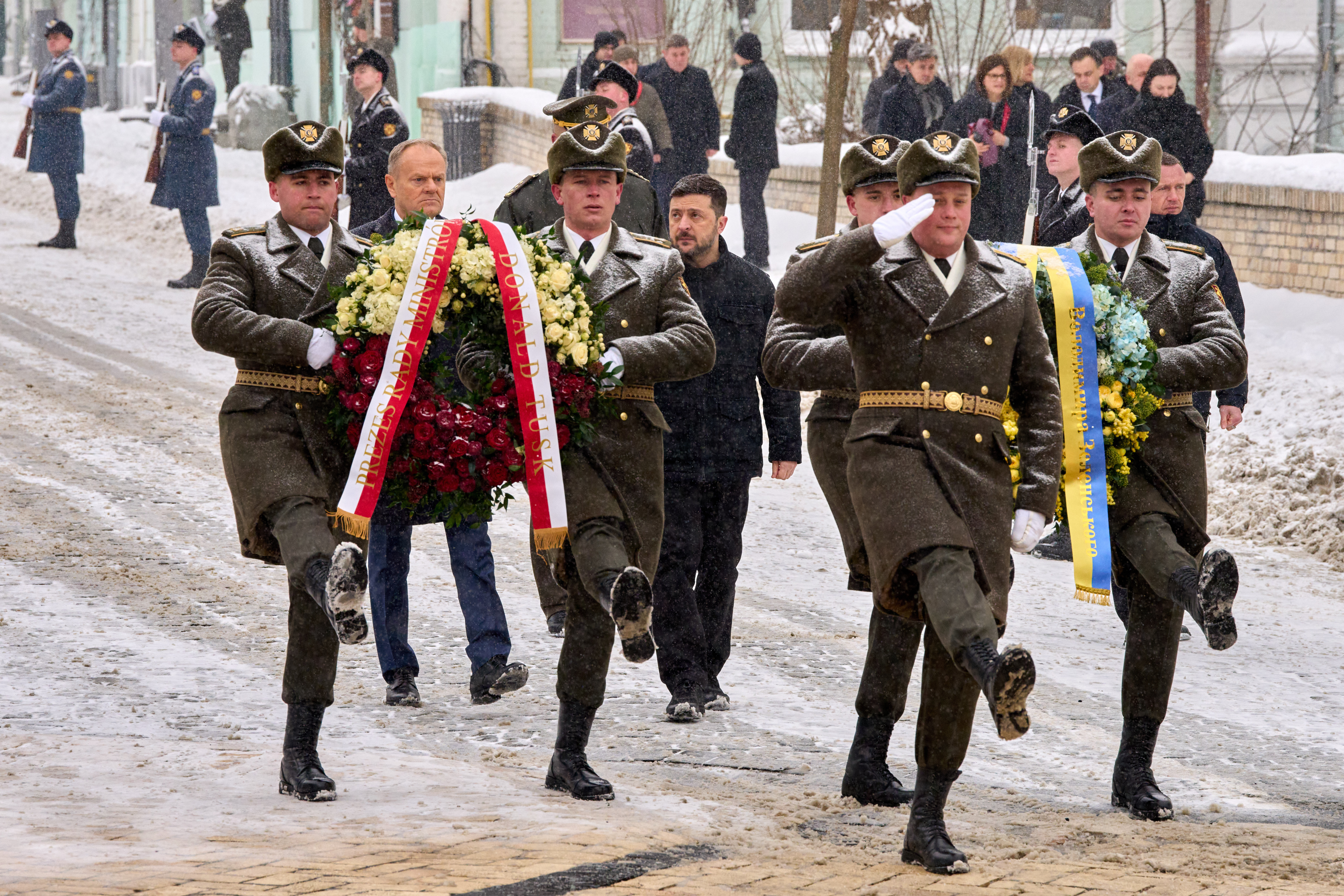 Poland's Prime Minister Donald Tusk, second from left, and Ukrainian President Volodymyr Zelenskyy attend a commemorative ceremony at the Memorial Wall of Fallen Defenders of Ukraine in Kyiv, Ukraine, Thursday, Feb. 5, 2026. (AP Photo/Efrem Lukatsky)