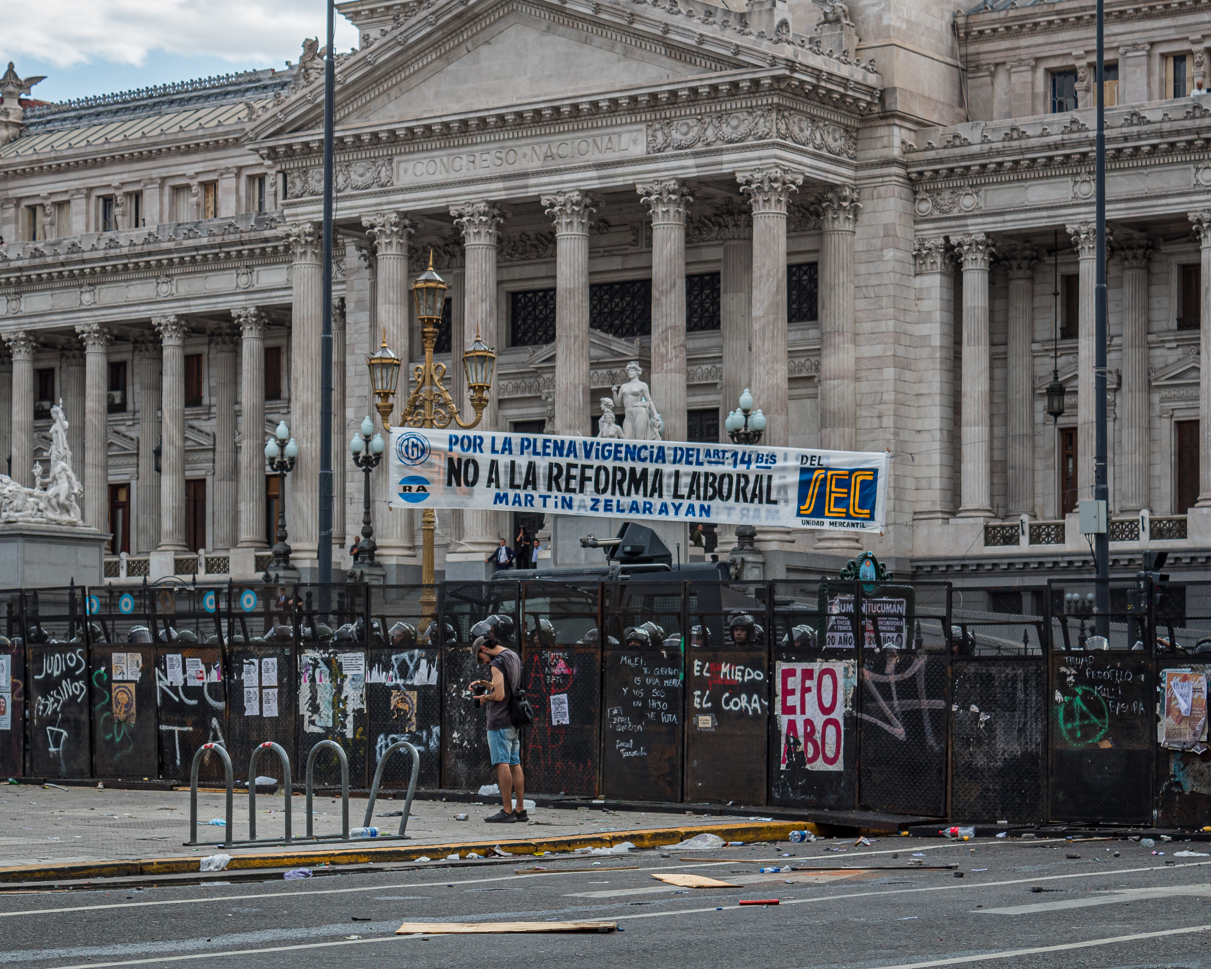 Police stand behind a metal barricade around Argentina's Congress