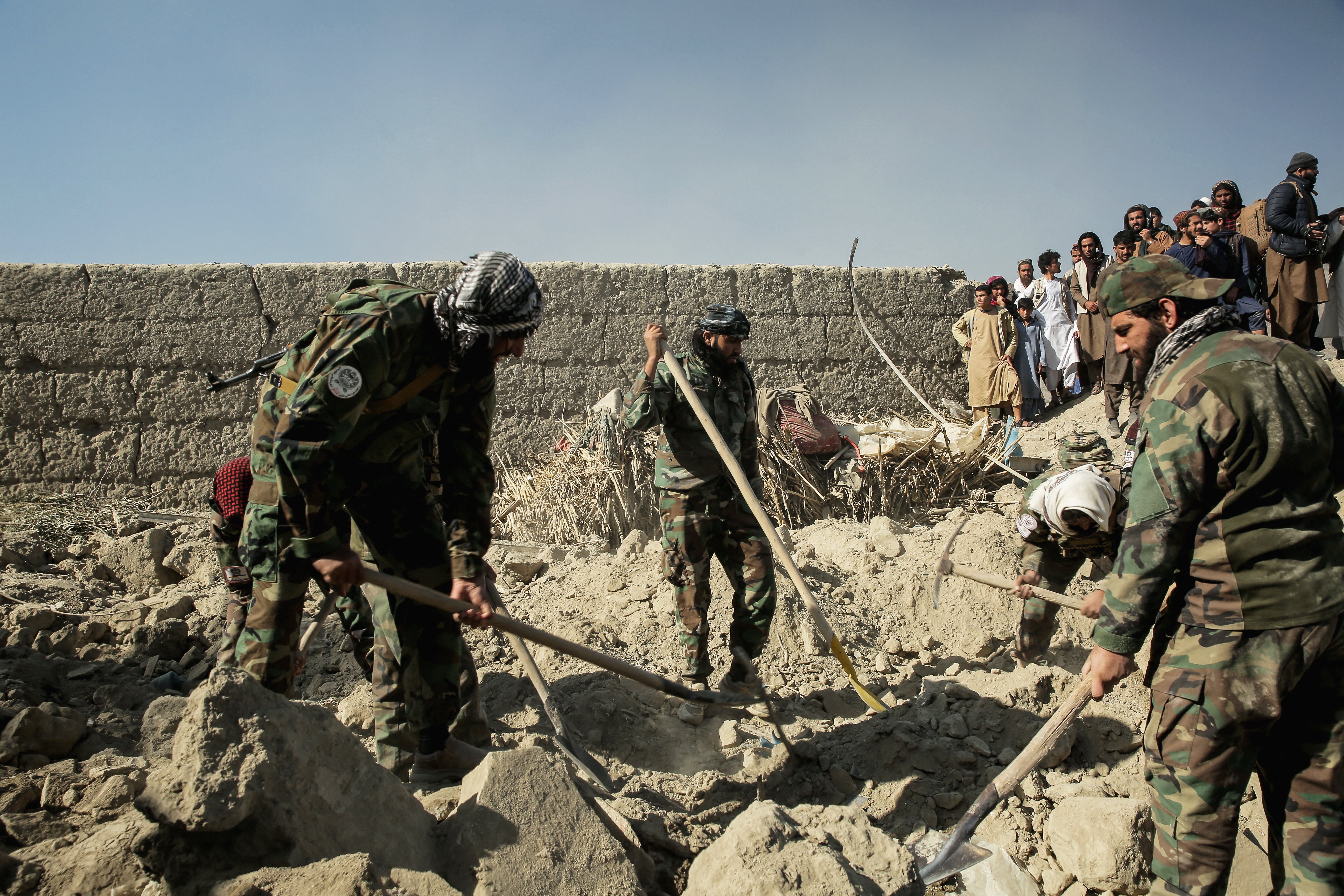Taliban security personnel search for victims after an overnight Pakistani air attack on a residential area in Bihsud district of Afghanistan's Nangarhar province