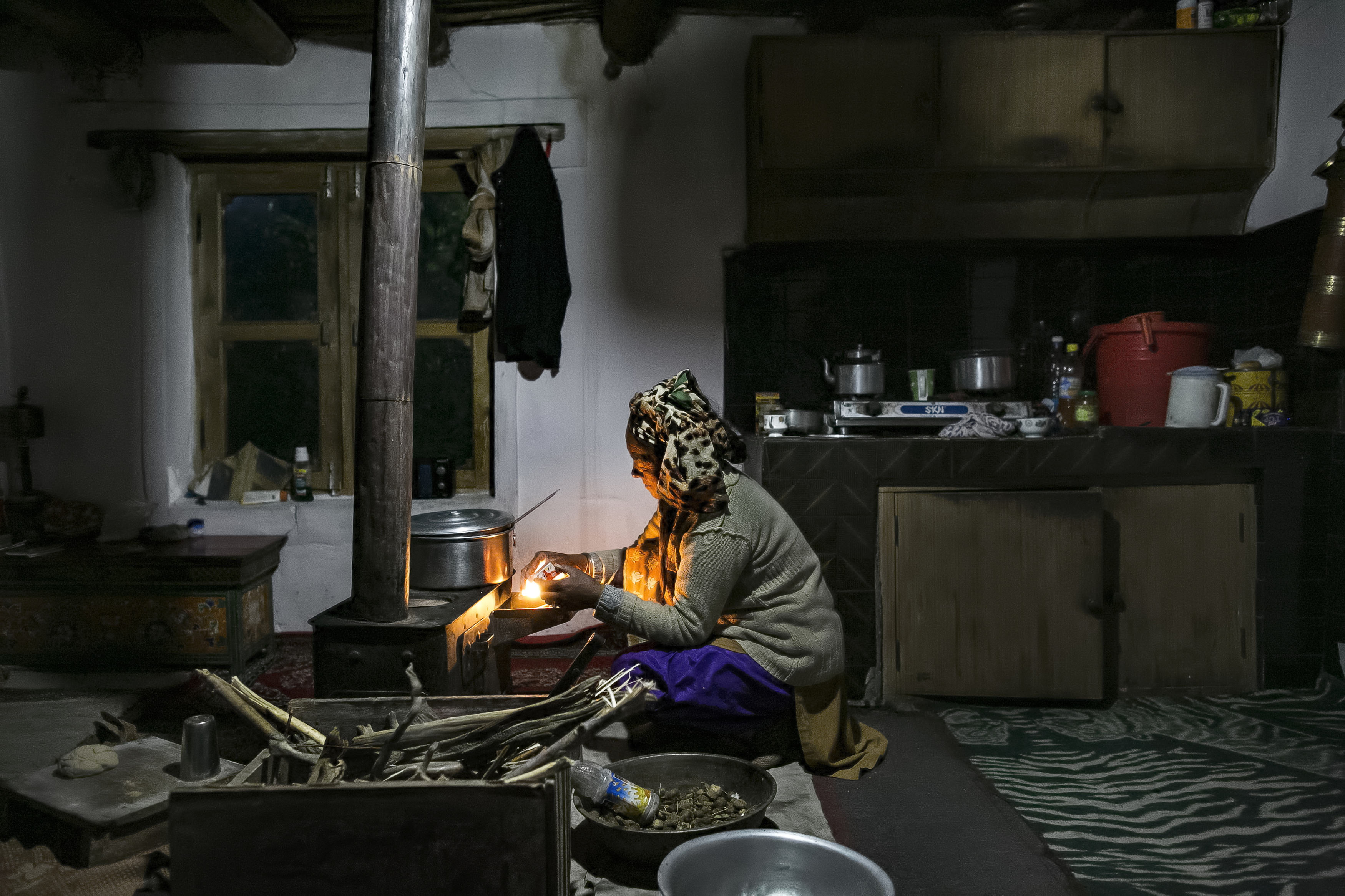 A person cooks by a solar light in Ladakh, India