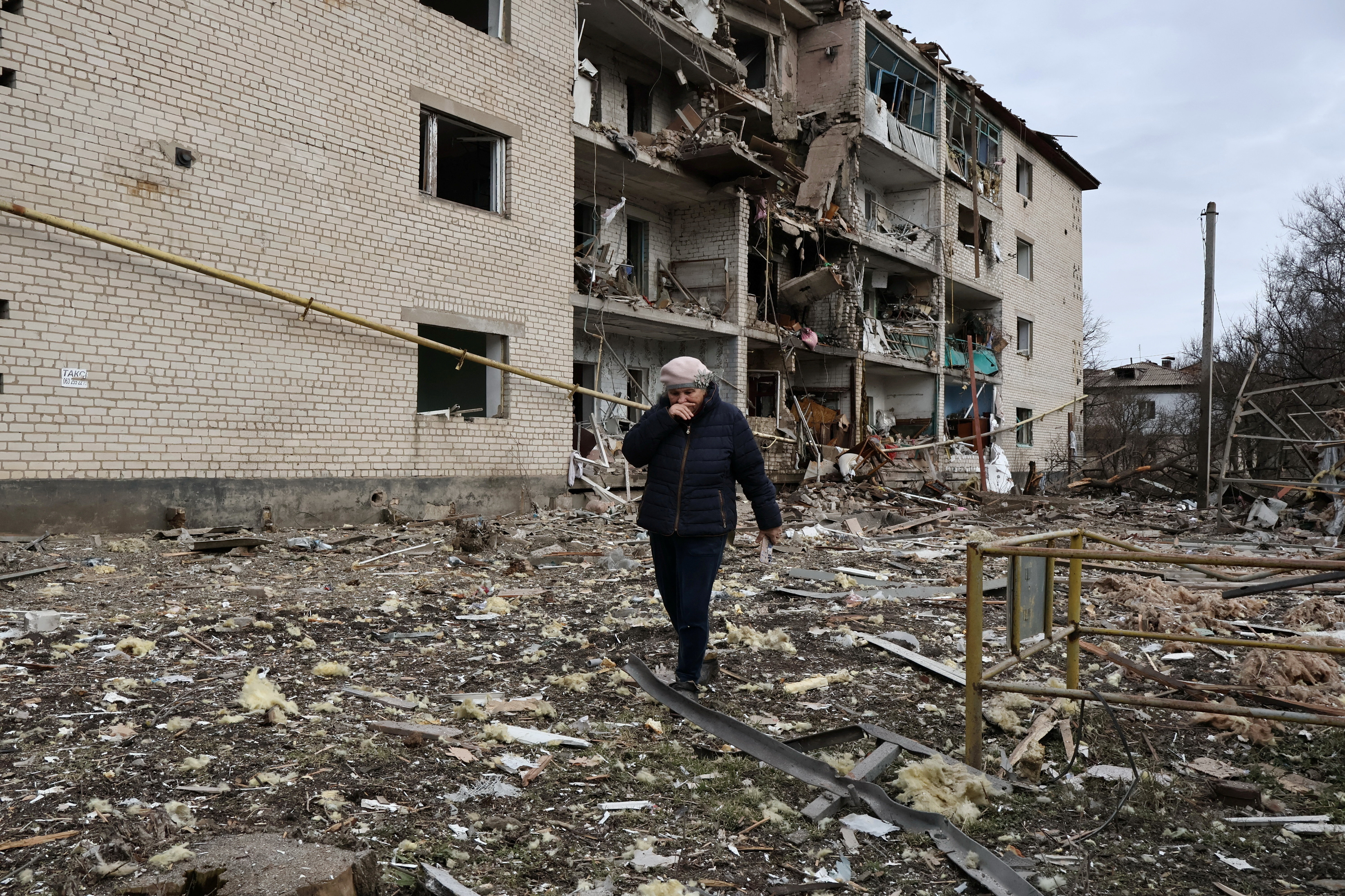 A resident walks in front of an apartment building hit by a Russian air strike in the town of Komyshuvakha, amid Russia's attack on Ukraine, in Zaporizhzhia region, Ukraine February 20, 2026. Andriy Andriyenko/Press Service of the 65th Separate Mechanized Brigade of the Ukrainian Armed Forces/Handout via REUTERS THIS IMAGE HAS BEEN SUPPLIED BY A THIRD PARTY.