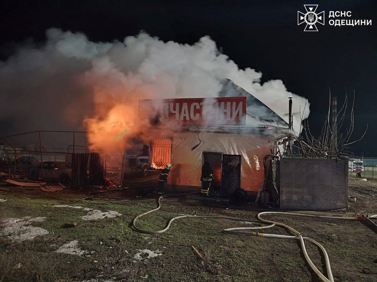 Firefighters work at a compound of a private enterprise which was damaged during overnight Russian drone attacks in Odesa region, Ukraine