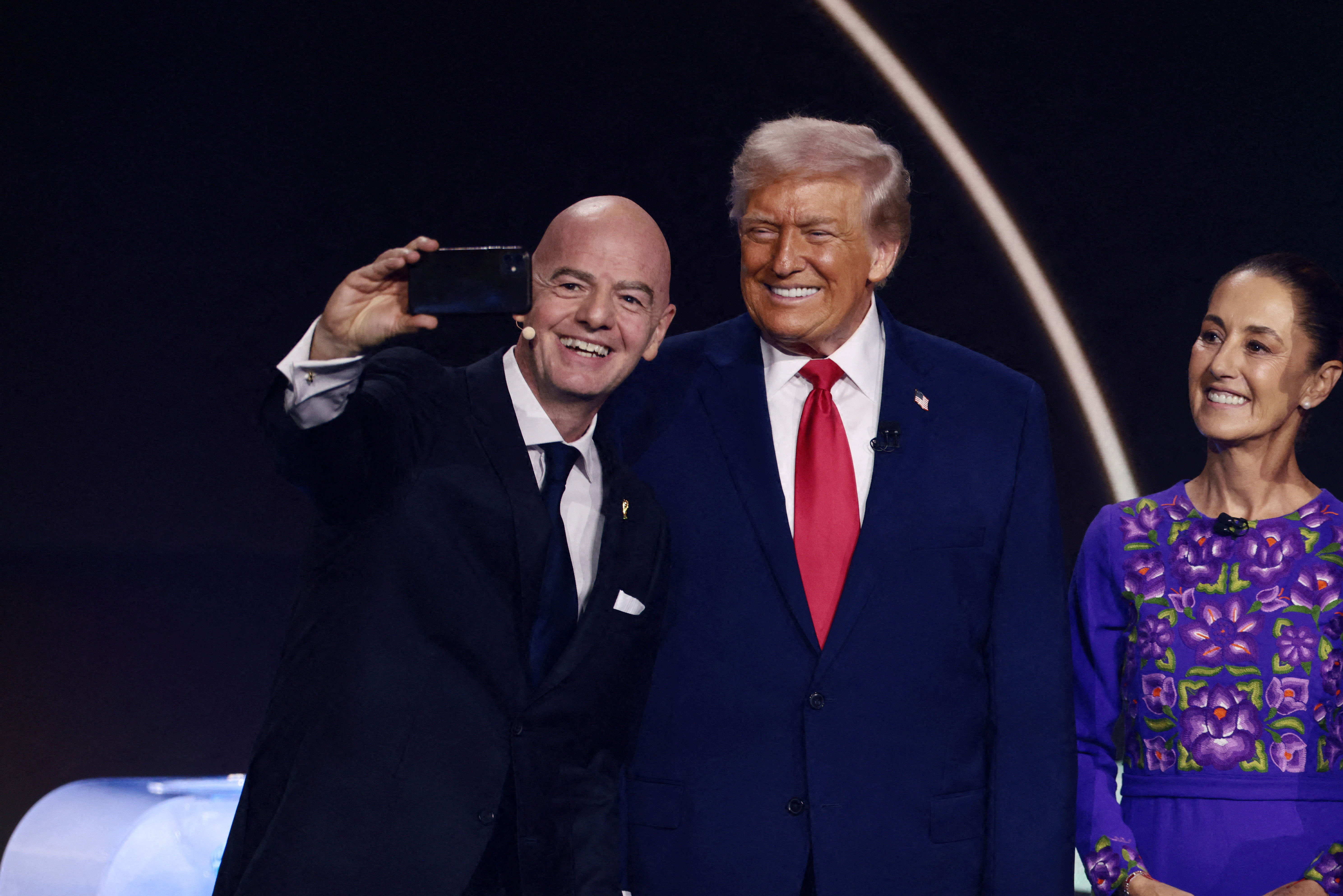 FIFA President Gianni Infantino, U.S. President Donald Trump, and Mexico's President Claudia Sheinbaum pose for a selfie during the FIFA World Cup 2026 Draw. [Evelyn Hockstein/Reuters]