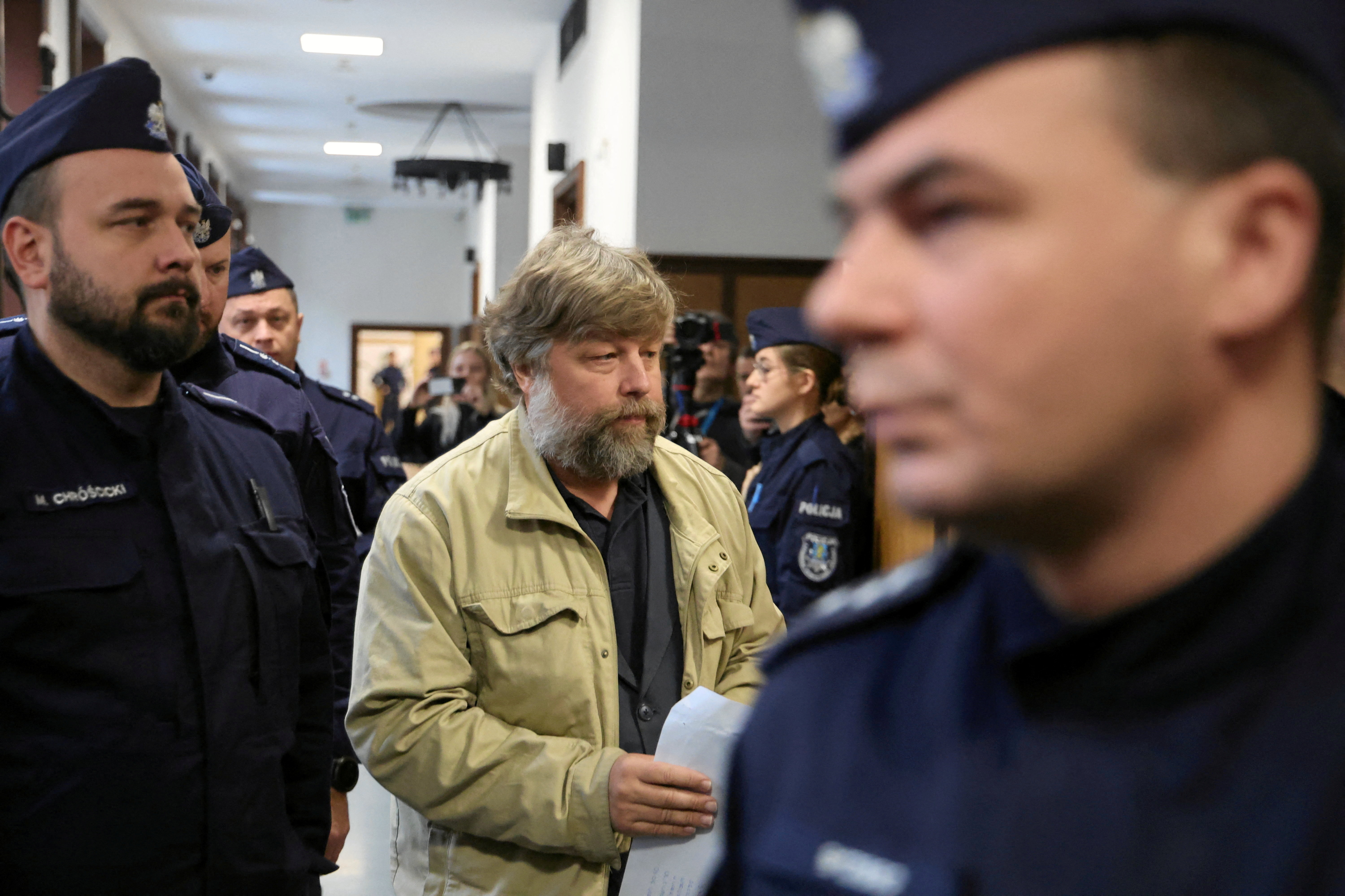 Russian archaeologist Alexander Butyagin, who is accused by Ukraine of unauthorised excavation and plundering of historical artefacts in Crimea, is escorted by Polish police as he arrives at a district court in Warsaw, Poland, January 15, 2026. Robert Kowalewski/Agencja Wyborcza.pl via REUTERS ATTENTION EDITORS – THIS IMAGE WAS PROVIDED BY A THIRD PARTY. POLAND OUT. NO COMMERCIAL OR EDITORIAL SALES IN POLAND.
