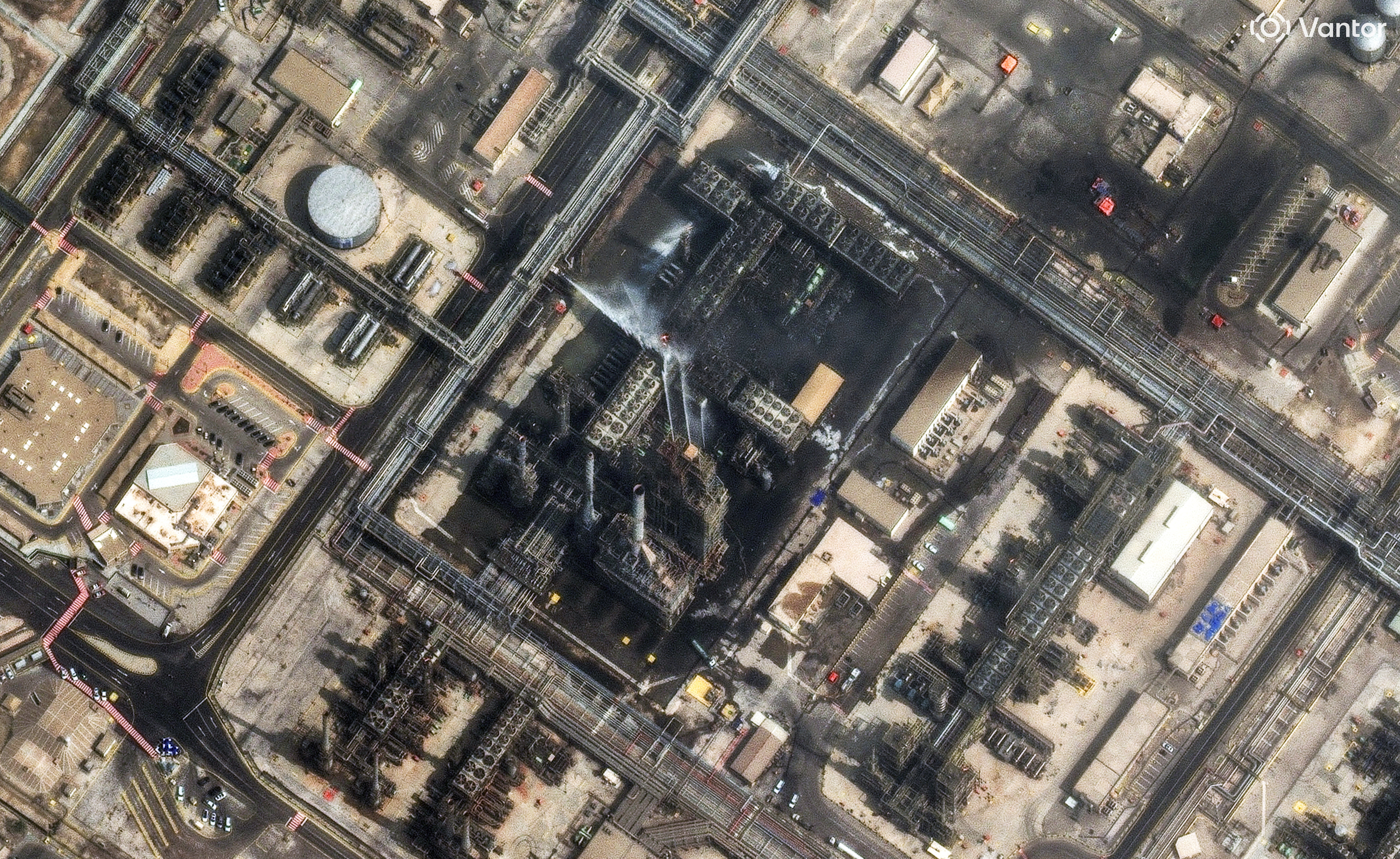 A satellite image shows efforts to control a fire in a refinery.