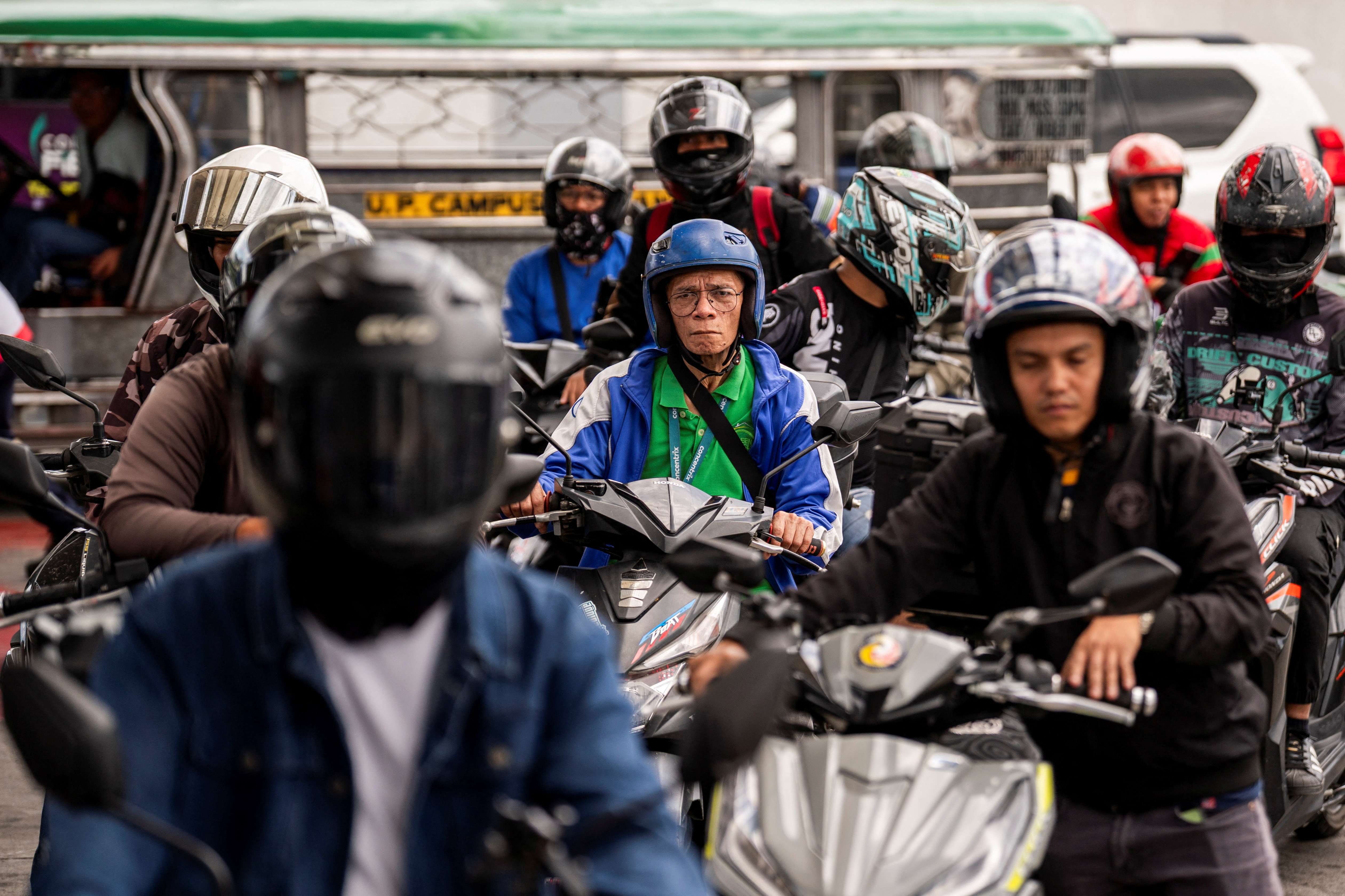 People queue at a gas station.