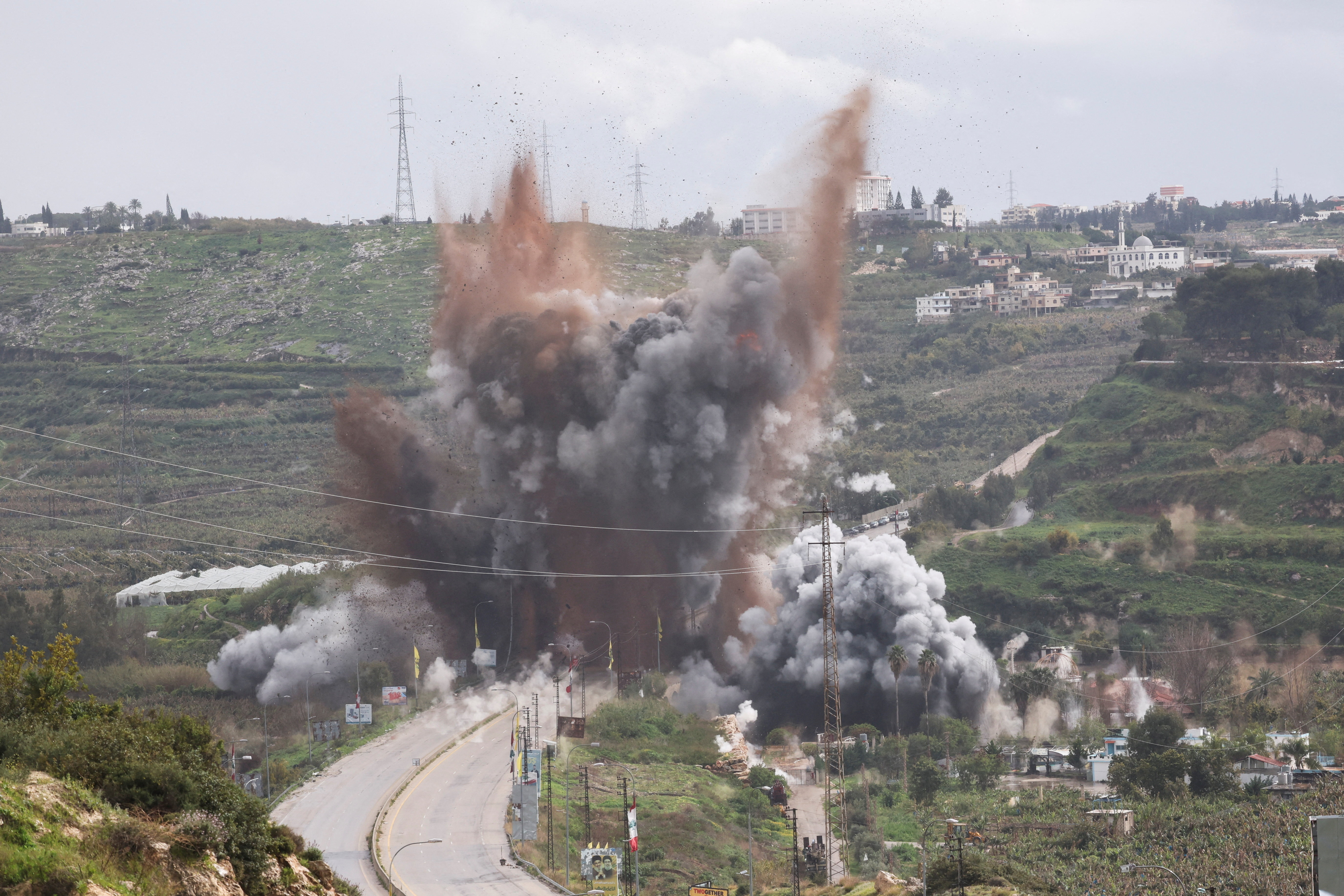 Smoke rises after an Israeli strike on a bridge, following an escalation between Hezbollah and Israel, amid the U.S.-Israeli conflict with Iran, near Qasmiyeh, Lebanon, March 22, 2026.