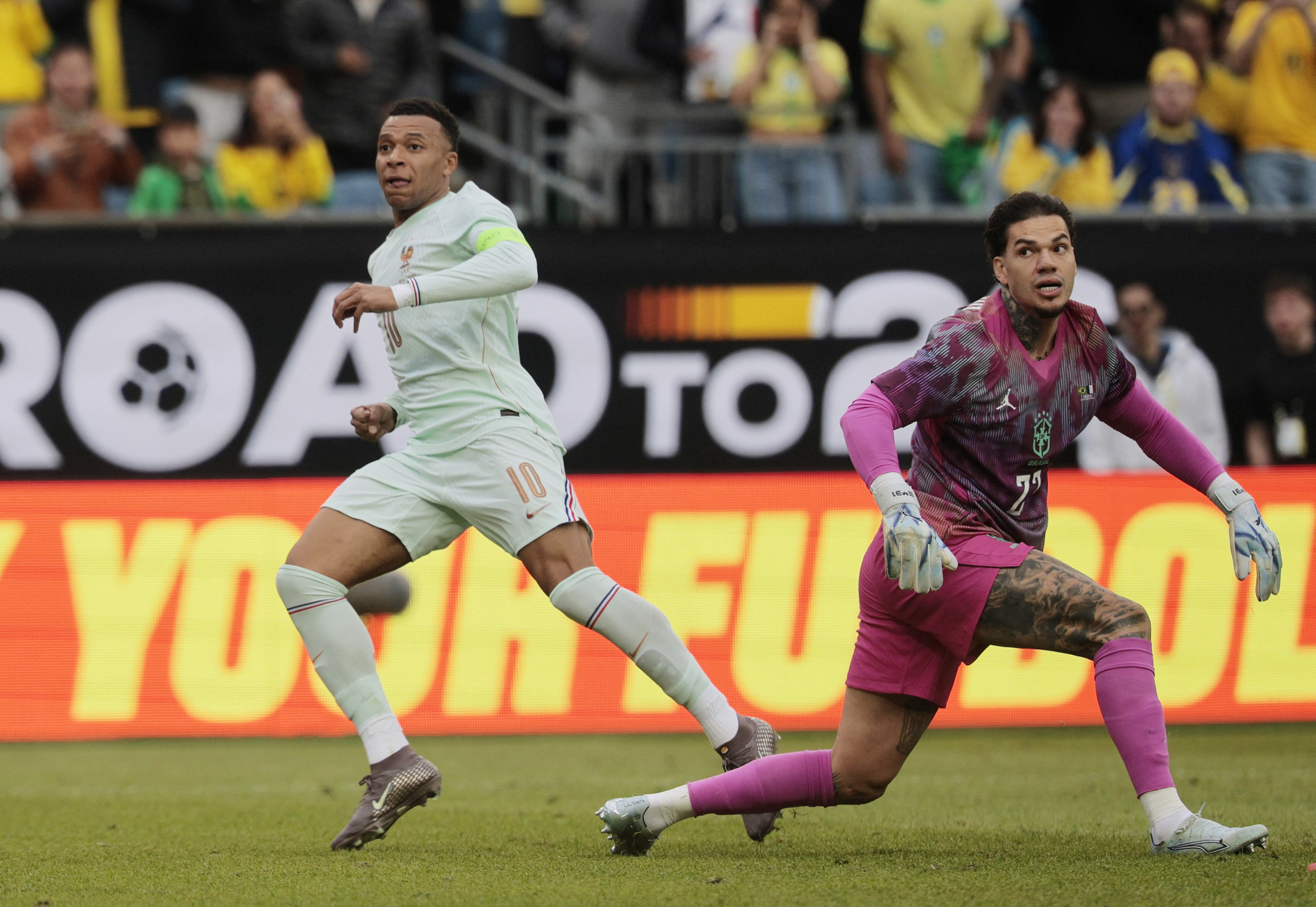 France's Kylian Mbappe scores their first goal as Brazil's Ederson looks on
