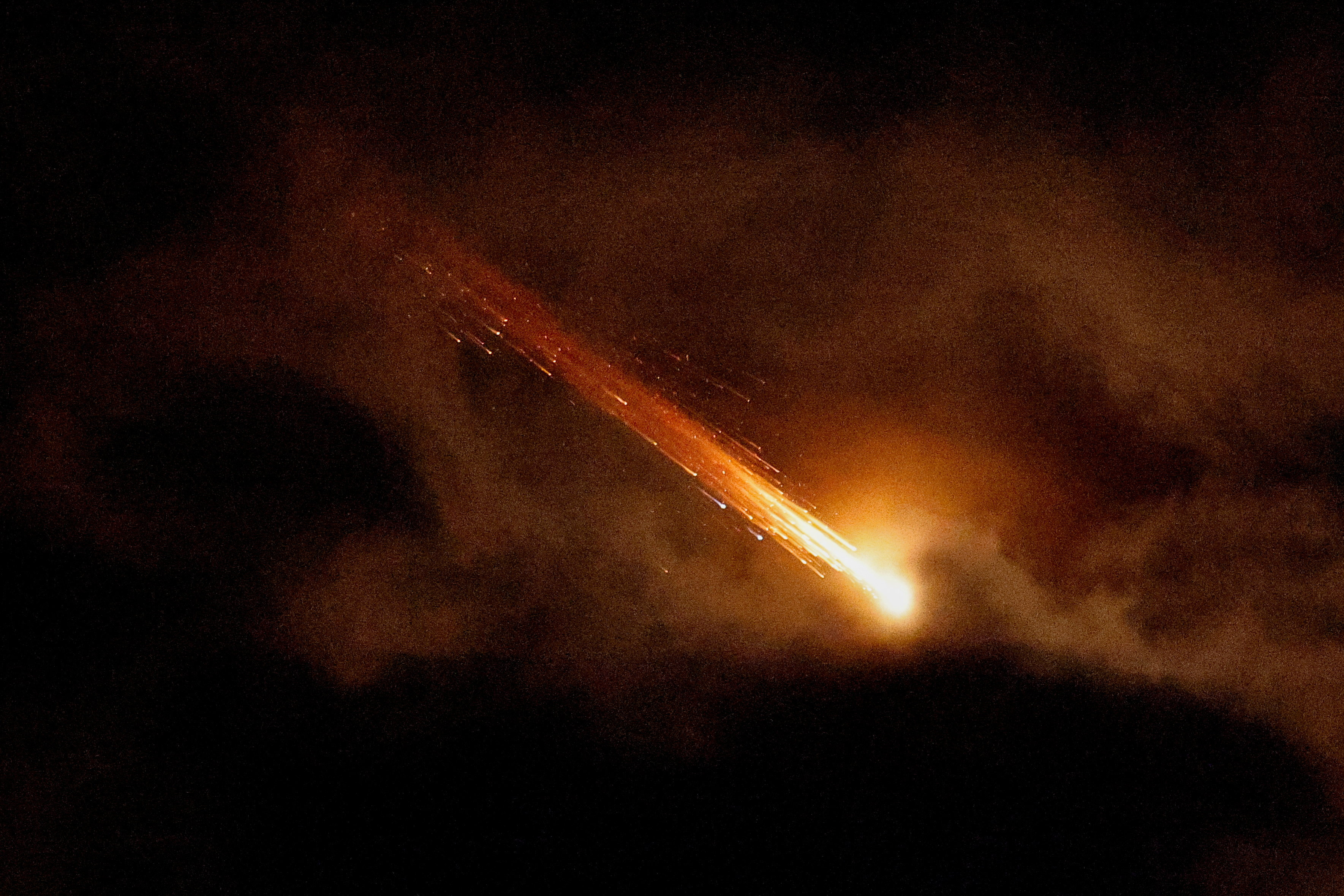 Streaks of light illuminate the sky during an interception attempt as seen from Ashkelon, Israel, March 28, 2026. [Amir Cohen/Reuters]