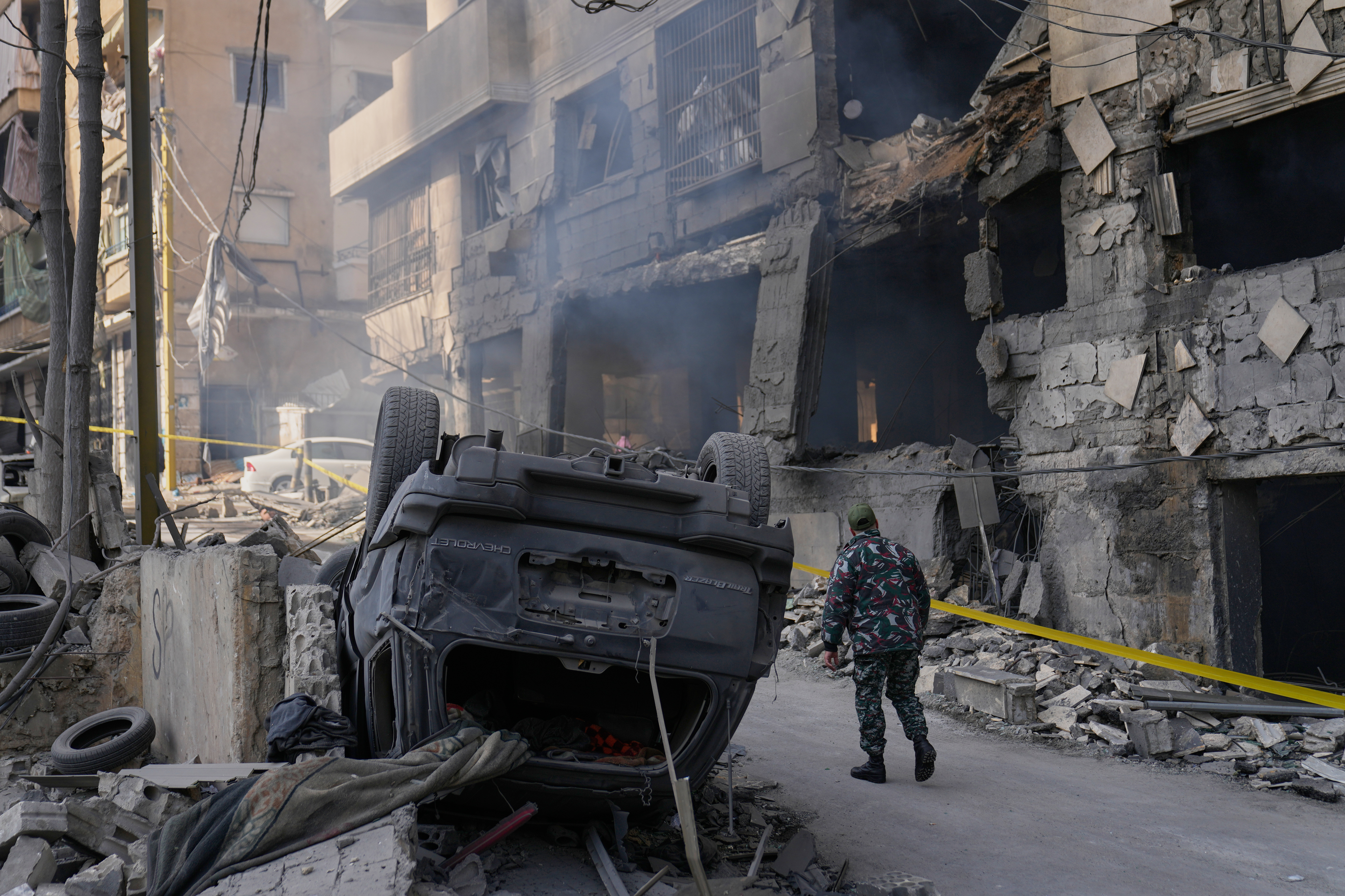 A firefighter checks the damage at a building.