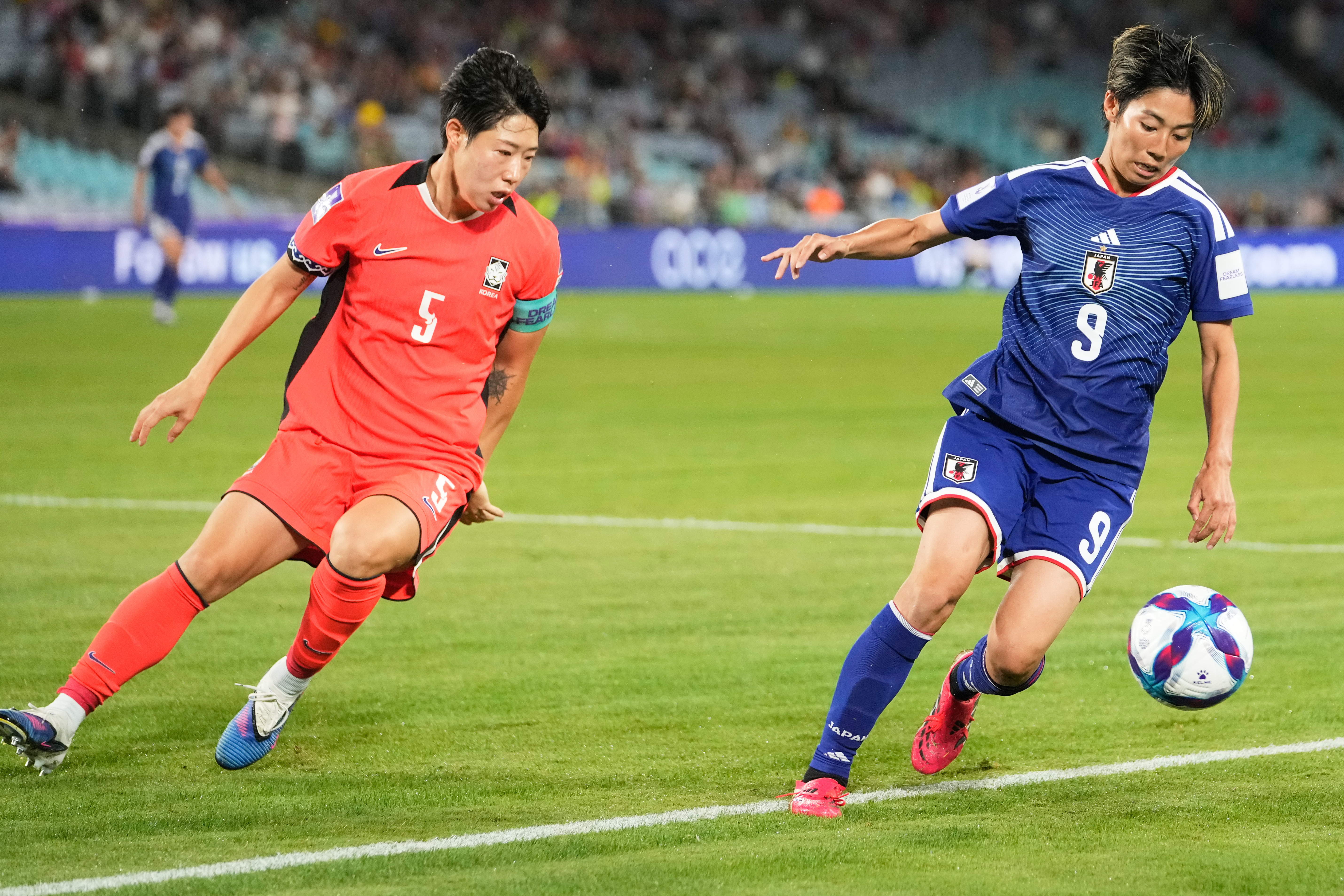 Japan's Riko Ueki, right, and South Korea's Ko Yoo-jin battle for the ball during the Women's Asian Cup semifinal soccer match between Japan and South Korea in Sydney, Wednesday, March 18, 2026. (AP Photo/Rick Rycroft)