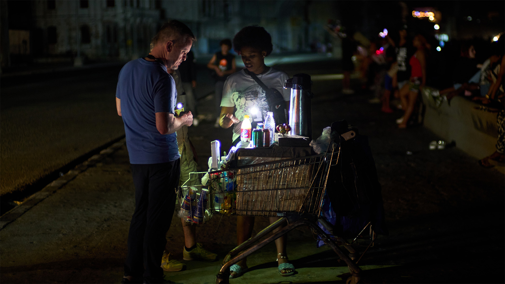 A street vendor tends to a customer on the Malecón during a blackout in Havana, Monday, March 16, 2026. (AP Photo/Ramon Espinosa)
