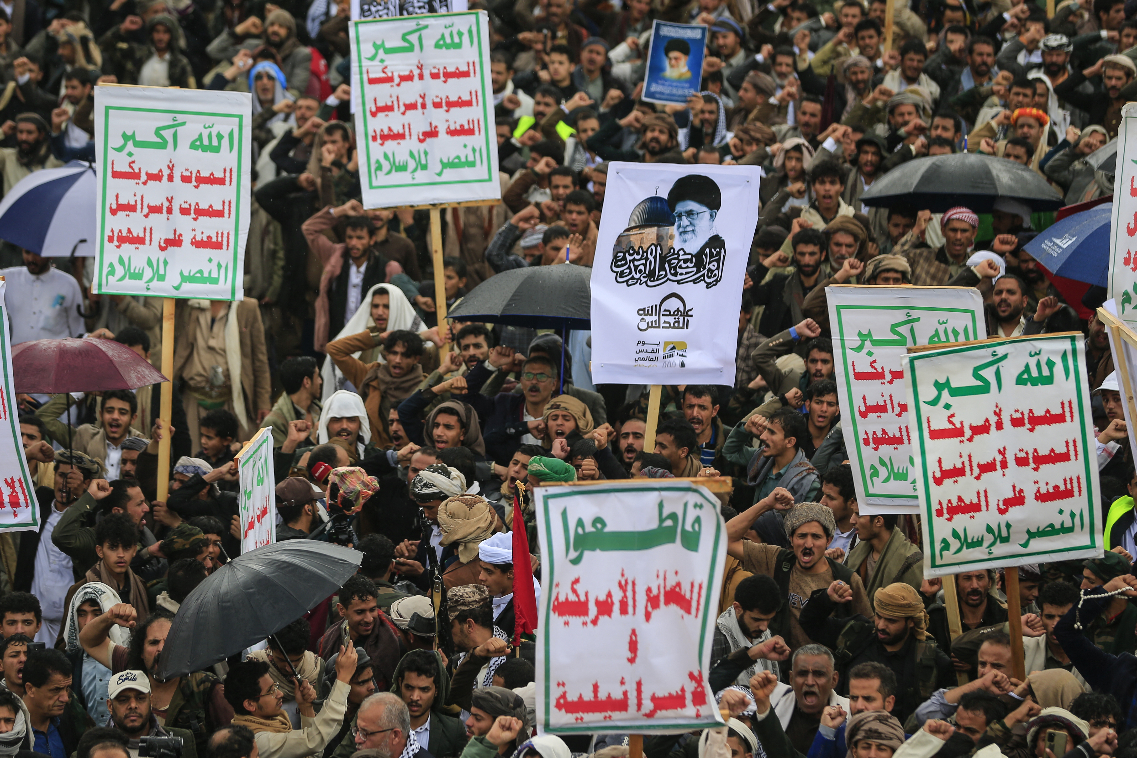 Supporters of Yemen's Houthi rebels hold a placard bearing a portrait of Iran’s slain supreme leader Ayatollah Ali Khamenei during the Al-Quds (Jerusalem) Day rally, a commemoration in support of the Palestinian people on the last Friday of the Islamic holy month of Ramadan, in Sanaa on March 13, 2026.