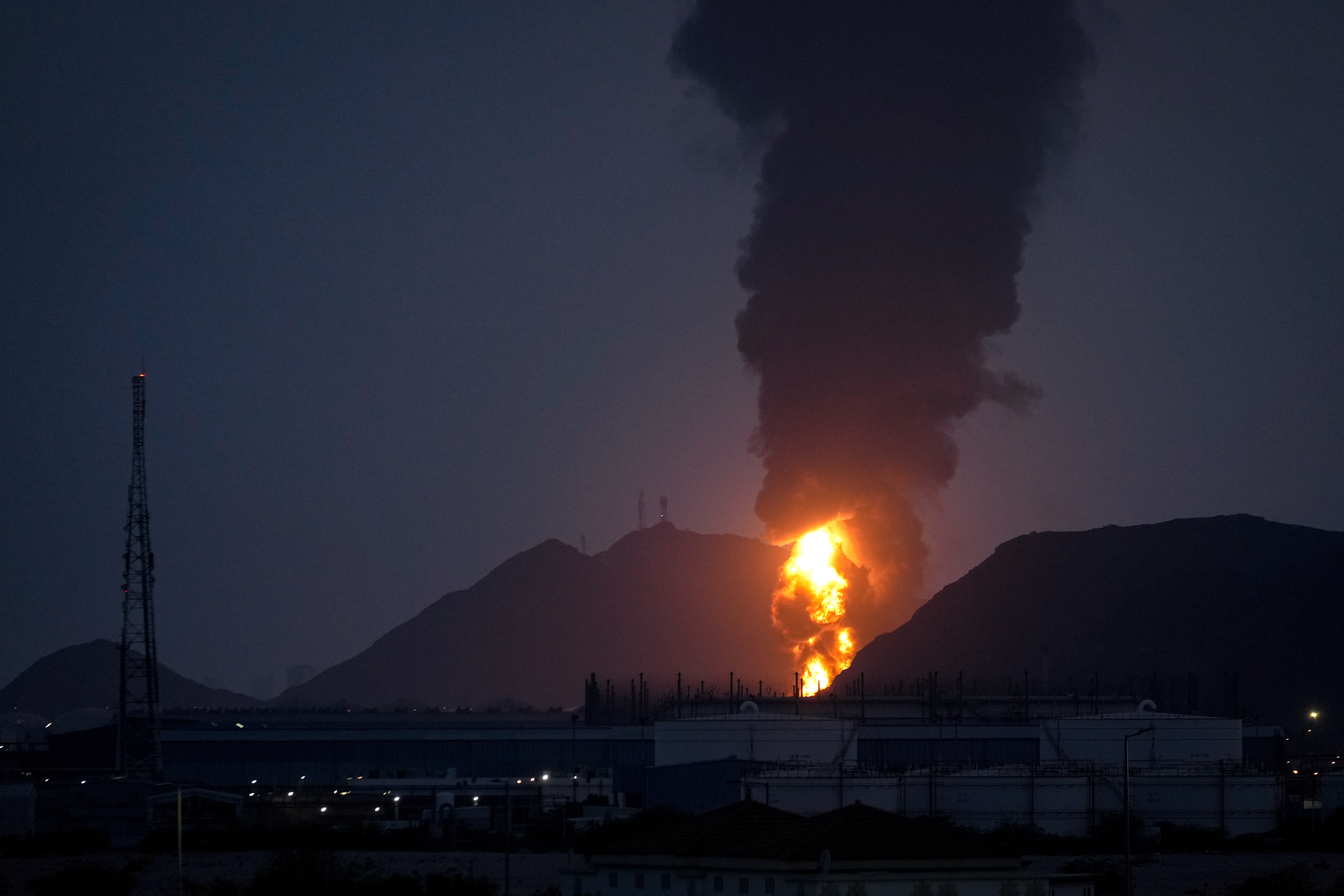Large fire and plume of smoke is visible after, according to the authorities, debris of an Iranian intercepted drone hit the Fujairah oil facility, in Fujairah, United Arab Emirates, Tuesday, March 3, 2026. (AP Photo/Altaf Qadri)