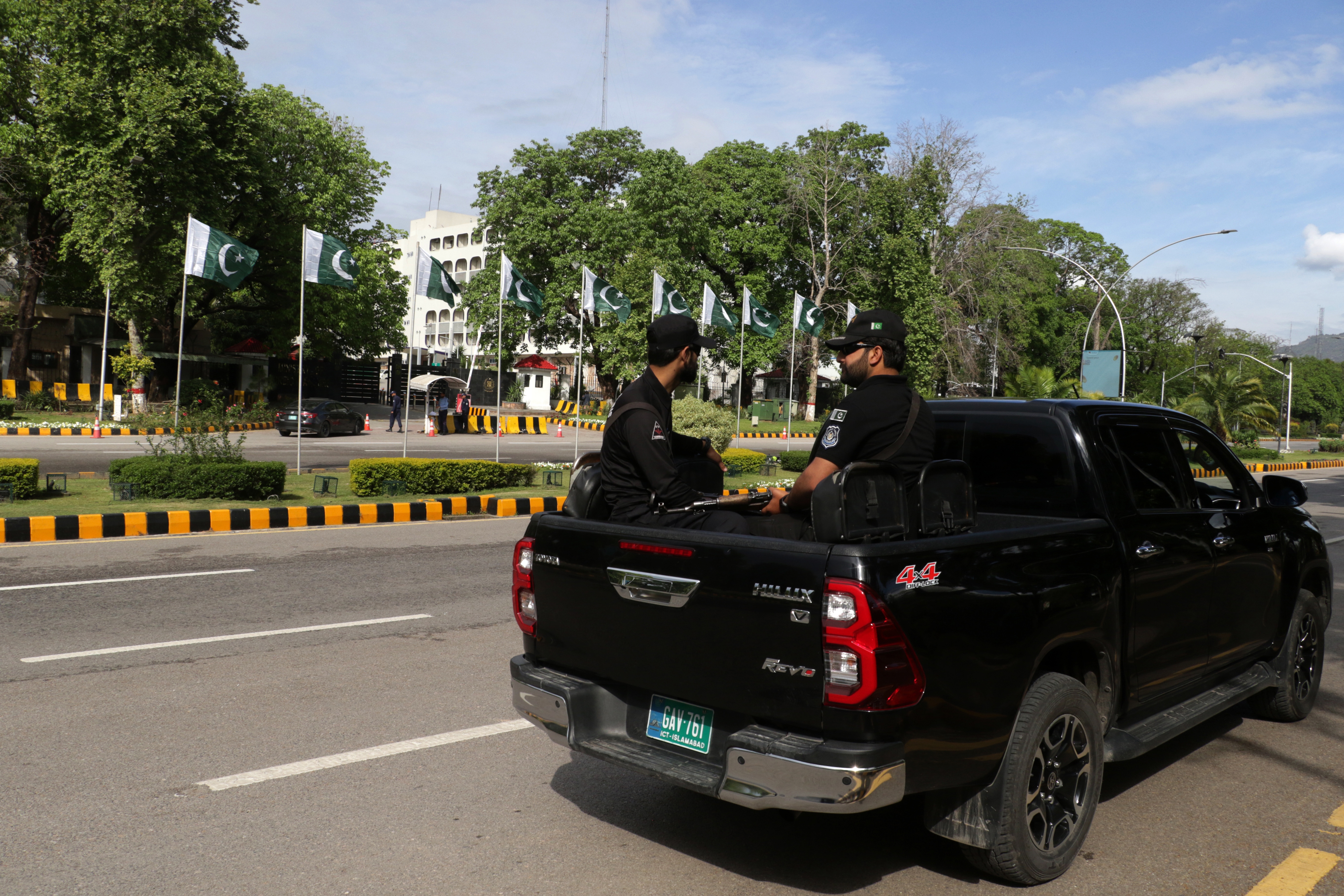 Pakistani security officials drive through the Red Zone where most of the diplomatic missions and government offices are located, as security has been intensified ahead of the visit of US and Iranian delegations in Islamabad, Pakistan. [Sohail Shahzad/EPA]