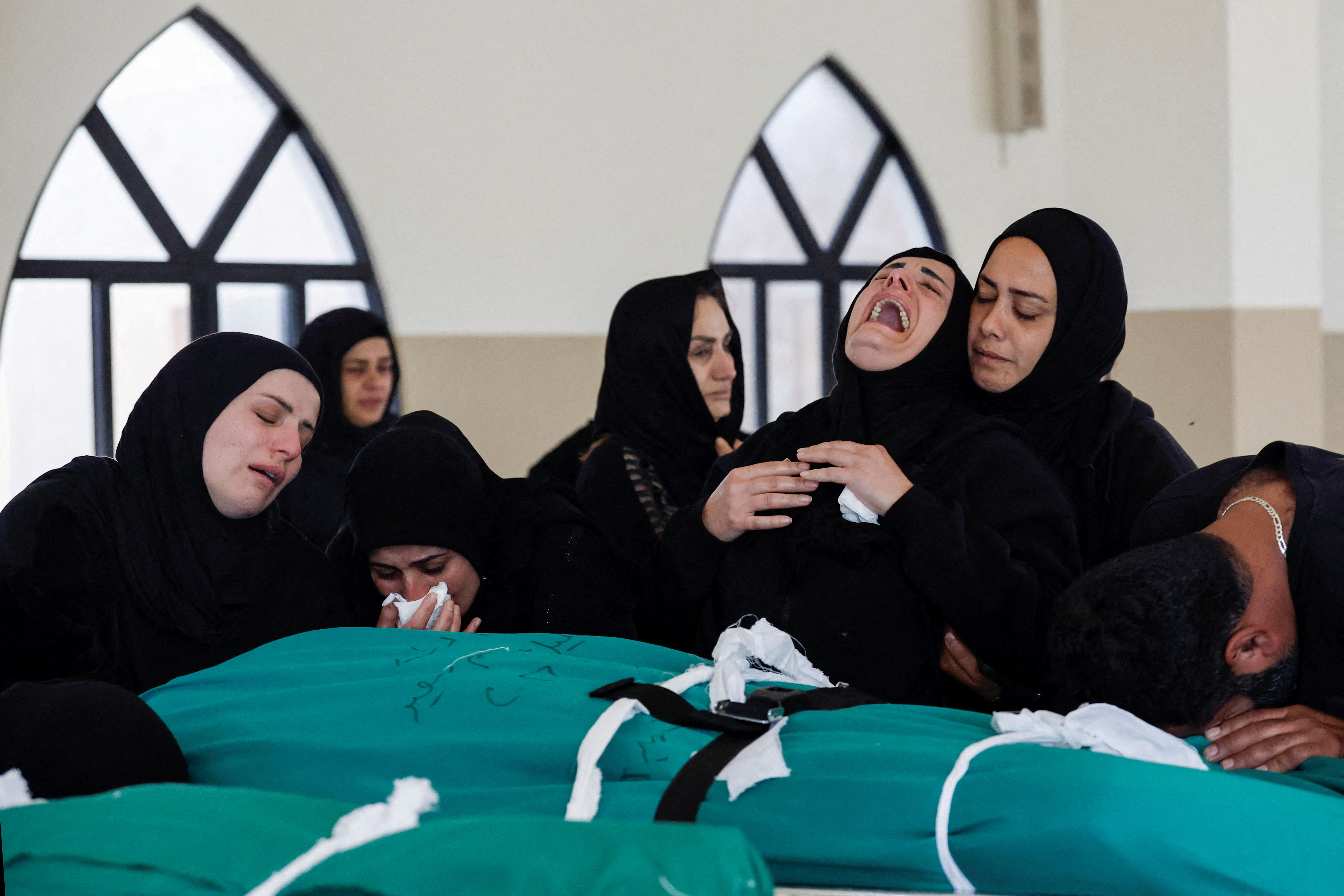 Relatives mourn over the bodies of four members of the Saeed family, Taleen (1.5 years old), Qassem (26), Khalil (60) and Fatima (39), killed in an Israeli strike in the village of Srifa, at the Al Kharab mosque in Tyre, Lebanon, April 12, 2026.