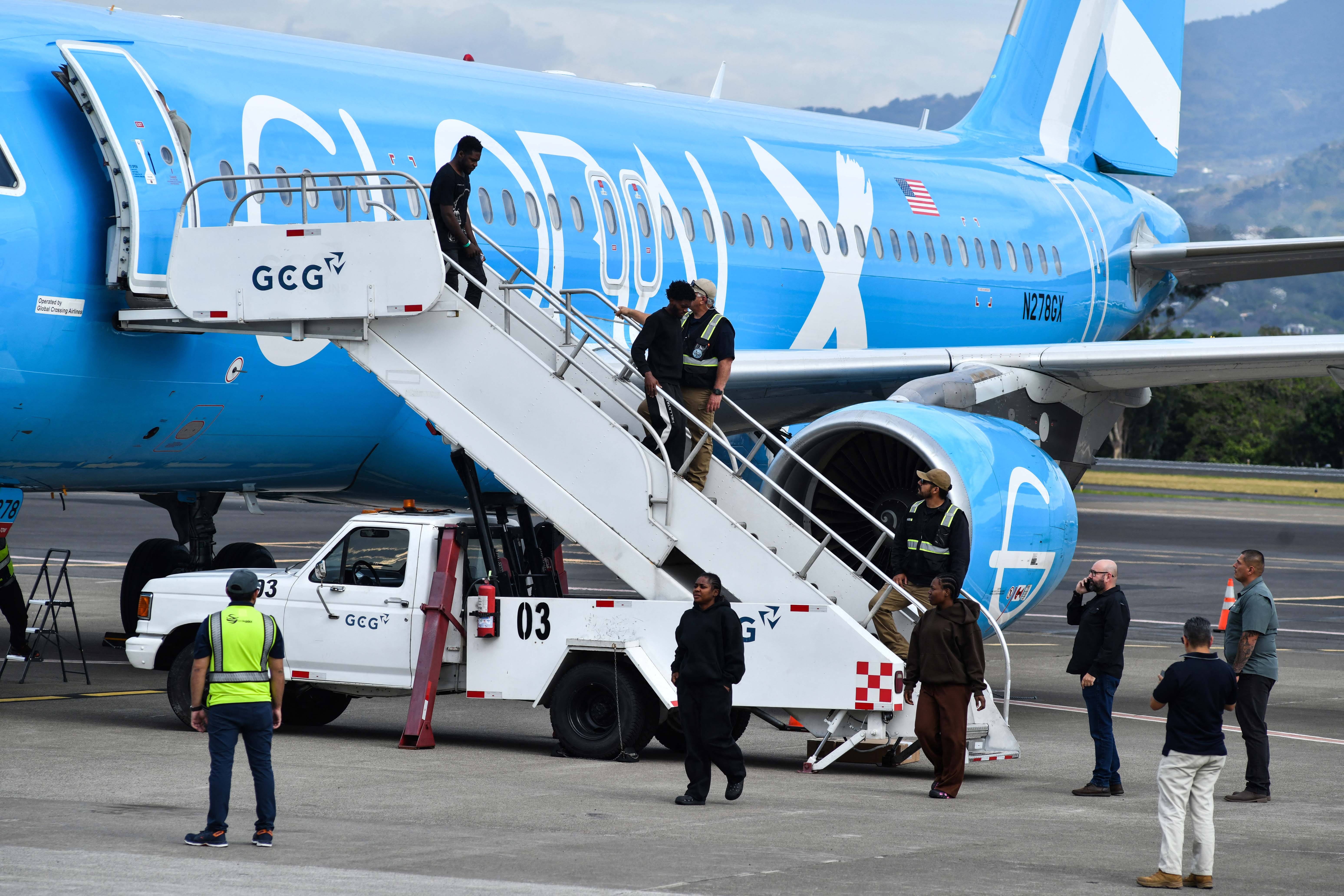Migrants deported from the United States get off an airliner at the runway of the Juan Santamaria International Airport in Alajuela, Costa Rica, on April 11, 2026. [Ezequiel Becerra/AFP]