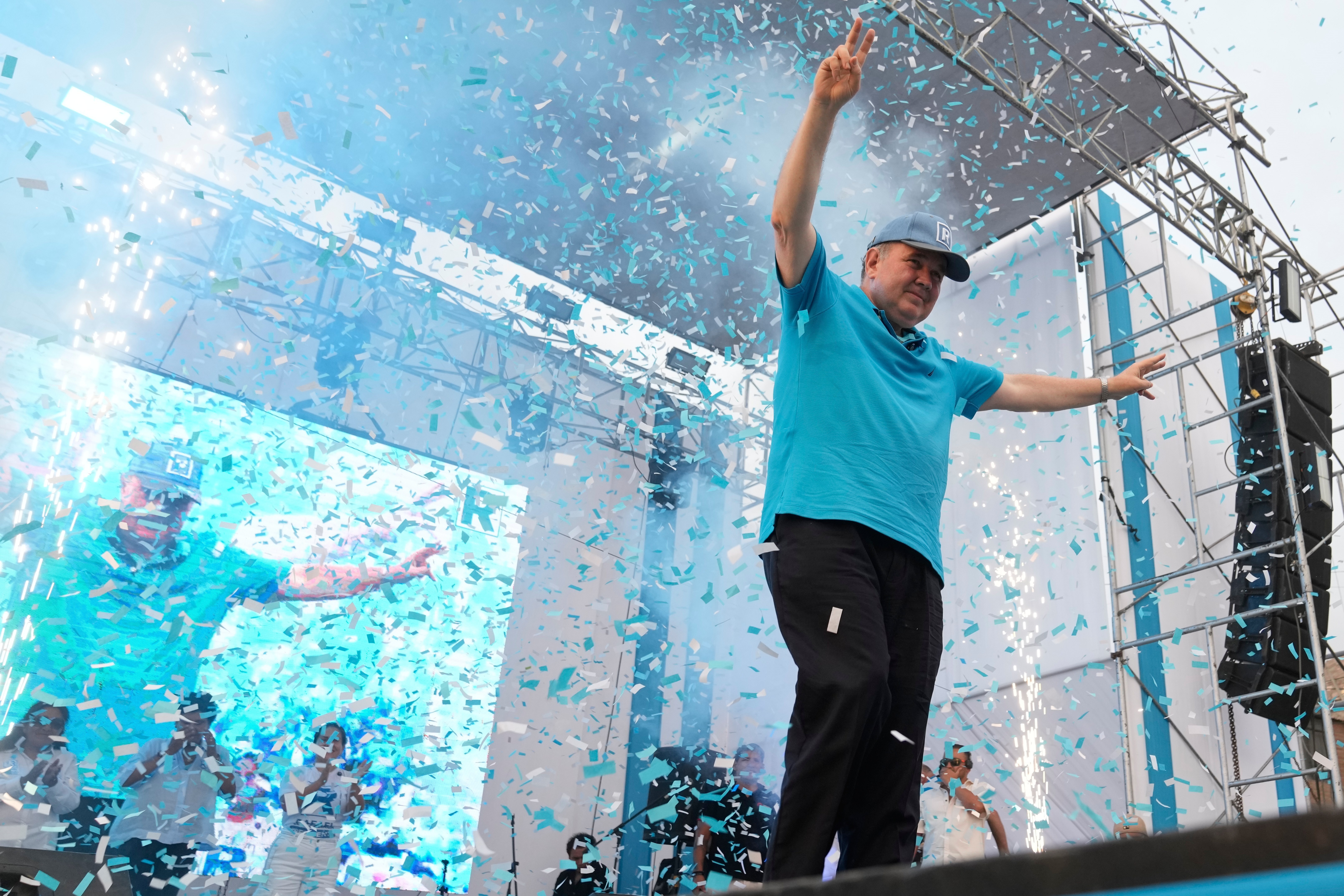 Presidential candidate Rafael López Aliaga, of the Popular Renewal party, greets supporters upon arriving at a campaign rally in the town of Huaycan outside Lima, Peru, Wednesday, March 18, 2026. (AP Photo/Martin Mejia)