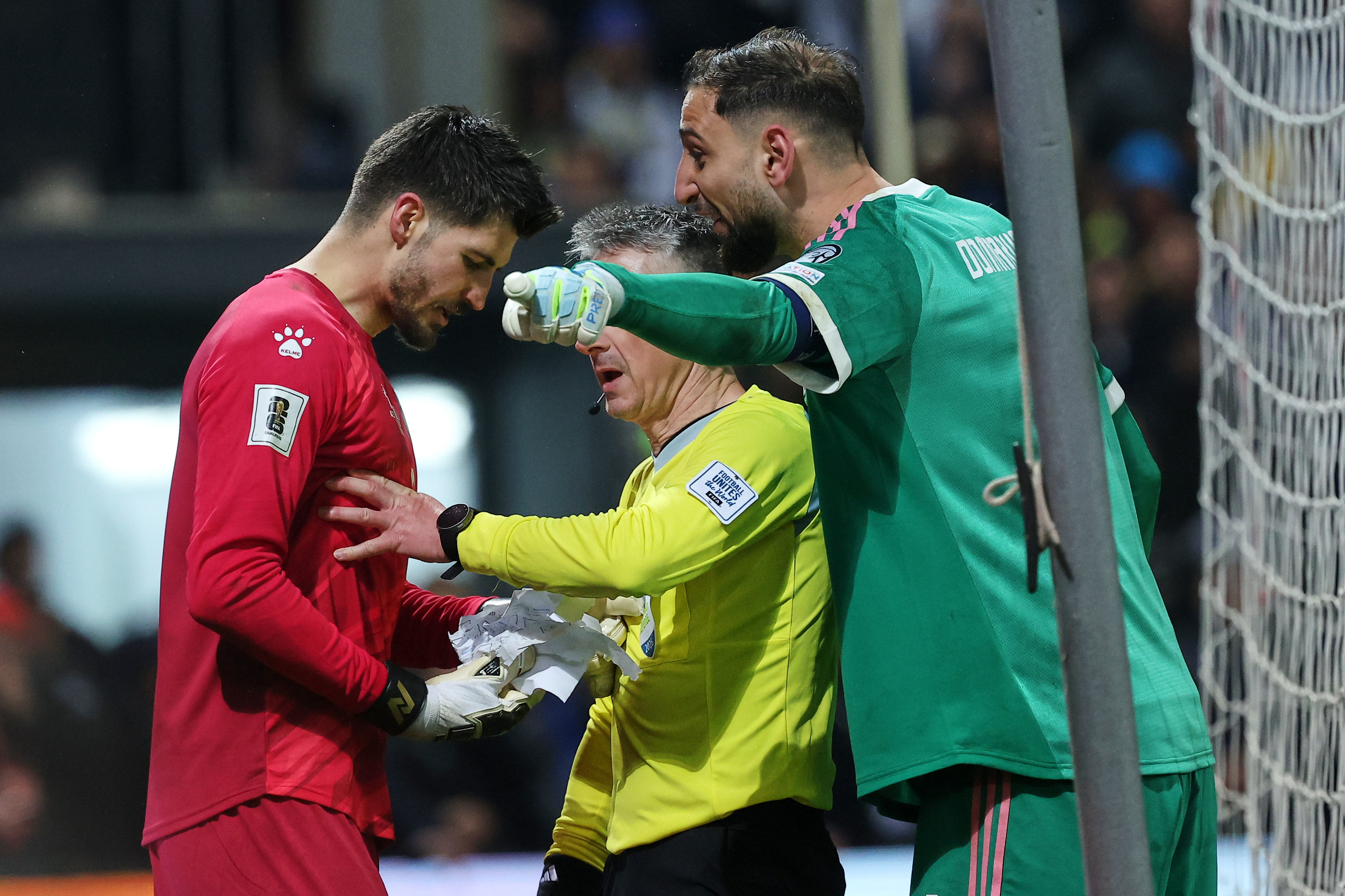 Bosnian goalkeeper Nikola Vasilj, left, and Italy goalkeeper Gianluigi Donnarumma argue during a penalty shootout during the World Cup qualifying playoff final soccer match between Bosnia and Italy in Zenica, Bosnia, Tuesday, March 31, 2026. (AP Photo/Armin Durgut)