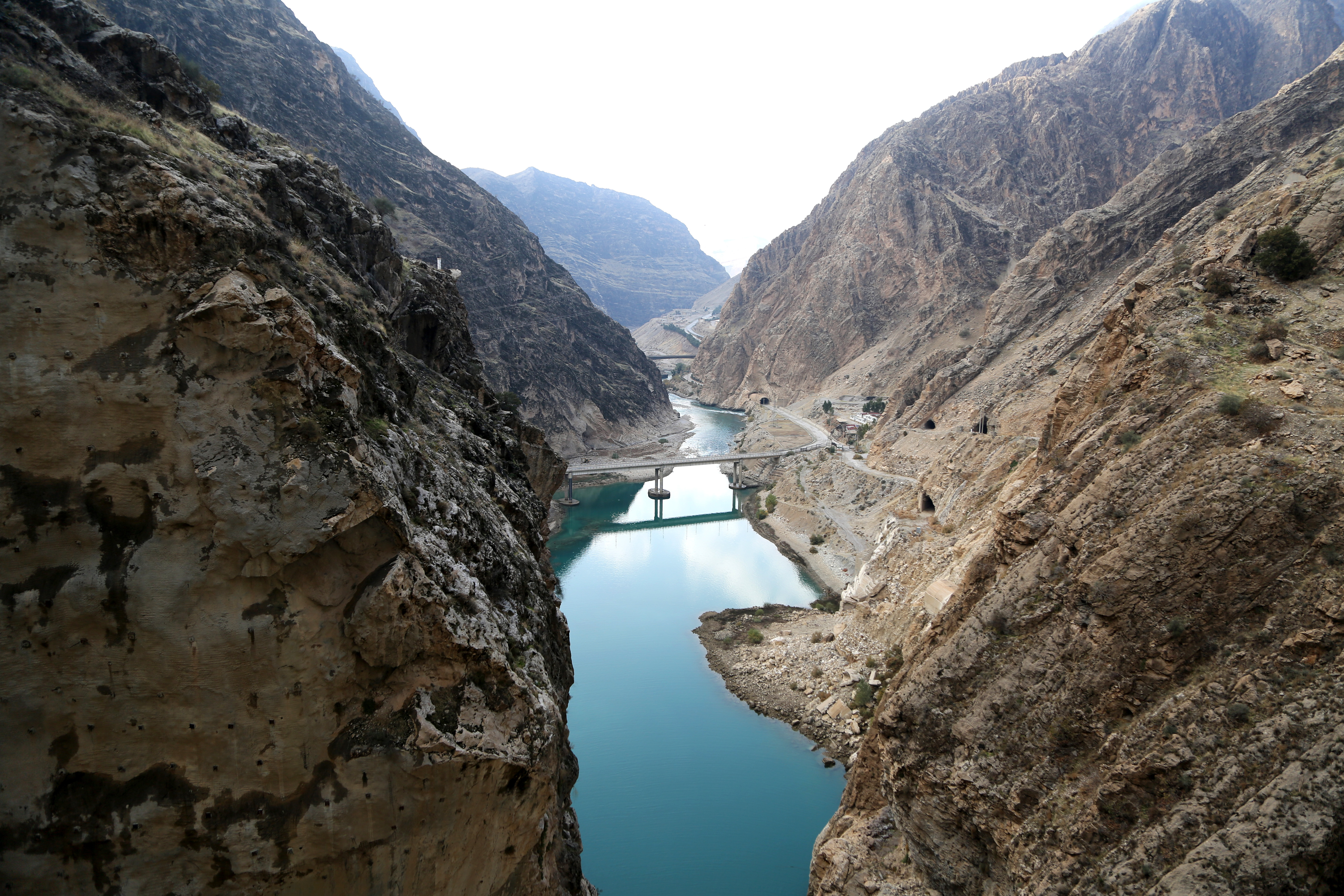 LORDEGAN, IRAN - DECEMBER 24: An aerial view of The Karun-4 Dam, the largest double-arch dam in the Middle East, on December 24, 2023 in Lordegan, Iran. Karun-4 is located in the city of Lordegan in Chaharmehal and Behtiyari Province. The dam is expected to generate 2100 gigawatts of energy annually and its arched bridge is known as the largest double-arched bridge in Iran with a height of 230 meters. According to IRNA news agency, 60 percent of the country's important dams are empty due to the lack of rainfall in the country this year. (Photo by Fatemeh Bahrami/Anadolu via Getty Images)