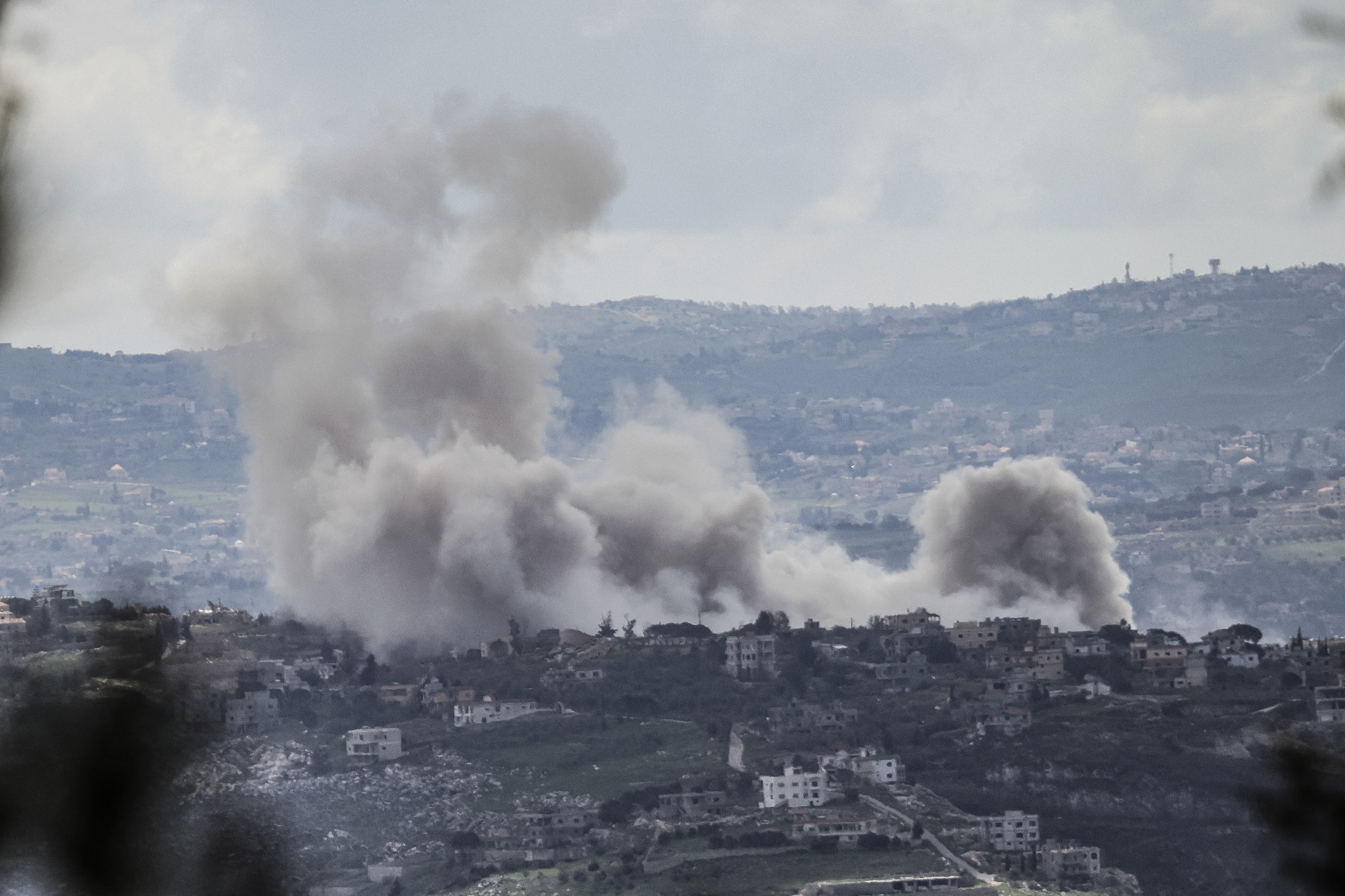 A photograph taken from the southern Lebanese area of Marjayoun shows smoke rising from explosions induced by Israeli military operations in the village of al-Taybeh on March 31, 2026.