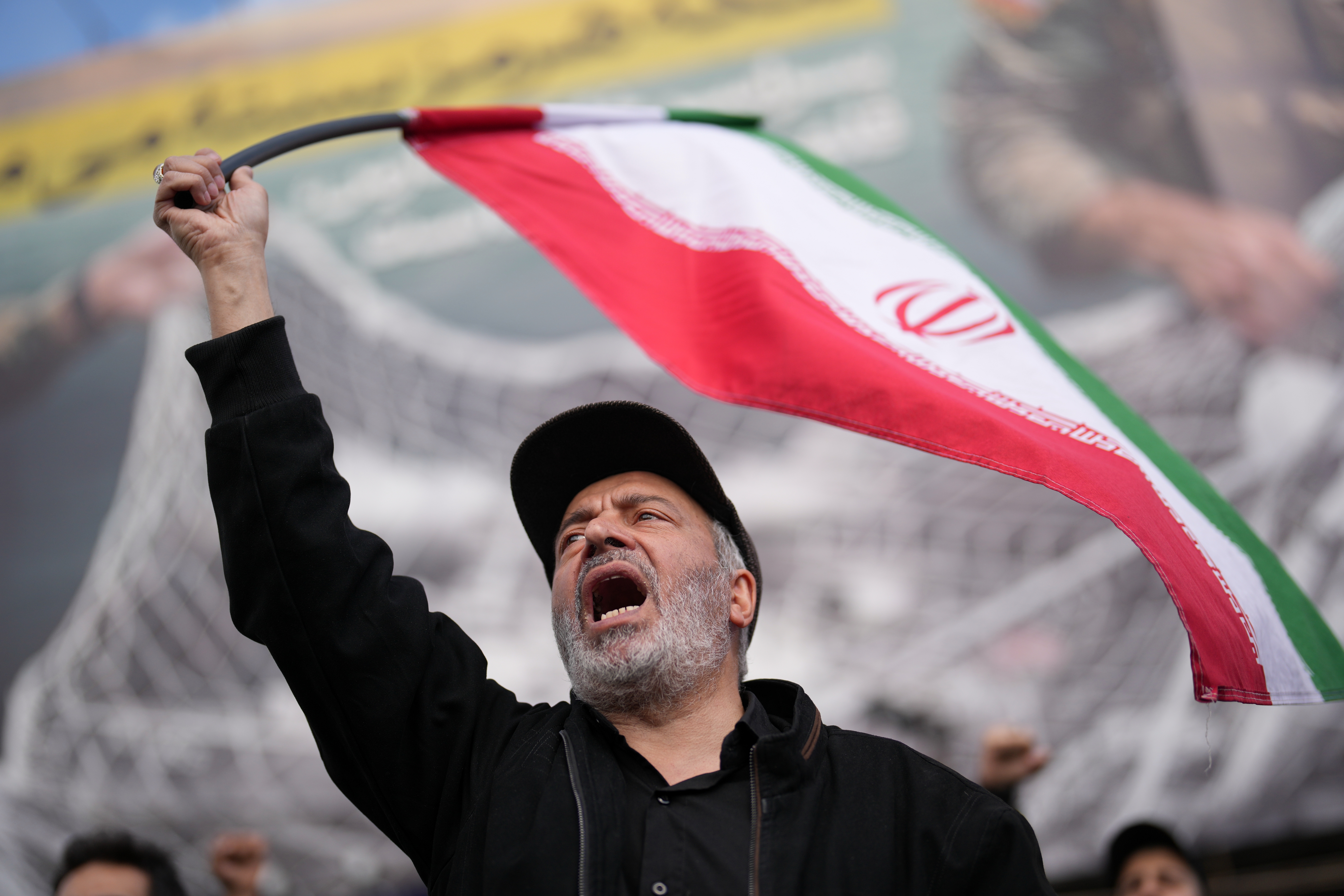 A government supporter chants slogans during a gathering after the announcement of a two-week ceasefire with the United States and Israel in Tehran, Iran, Wednesday, April 8, 2026. (AP Photo/Francisco Seco)