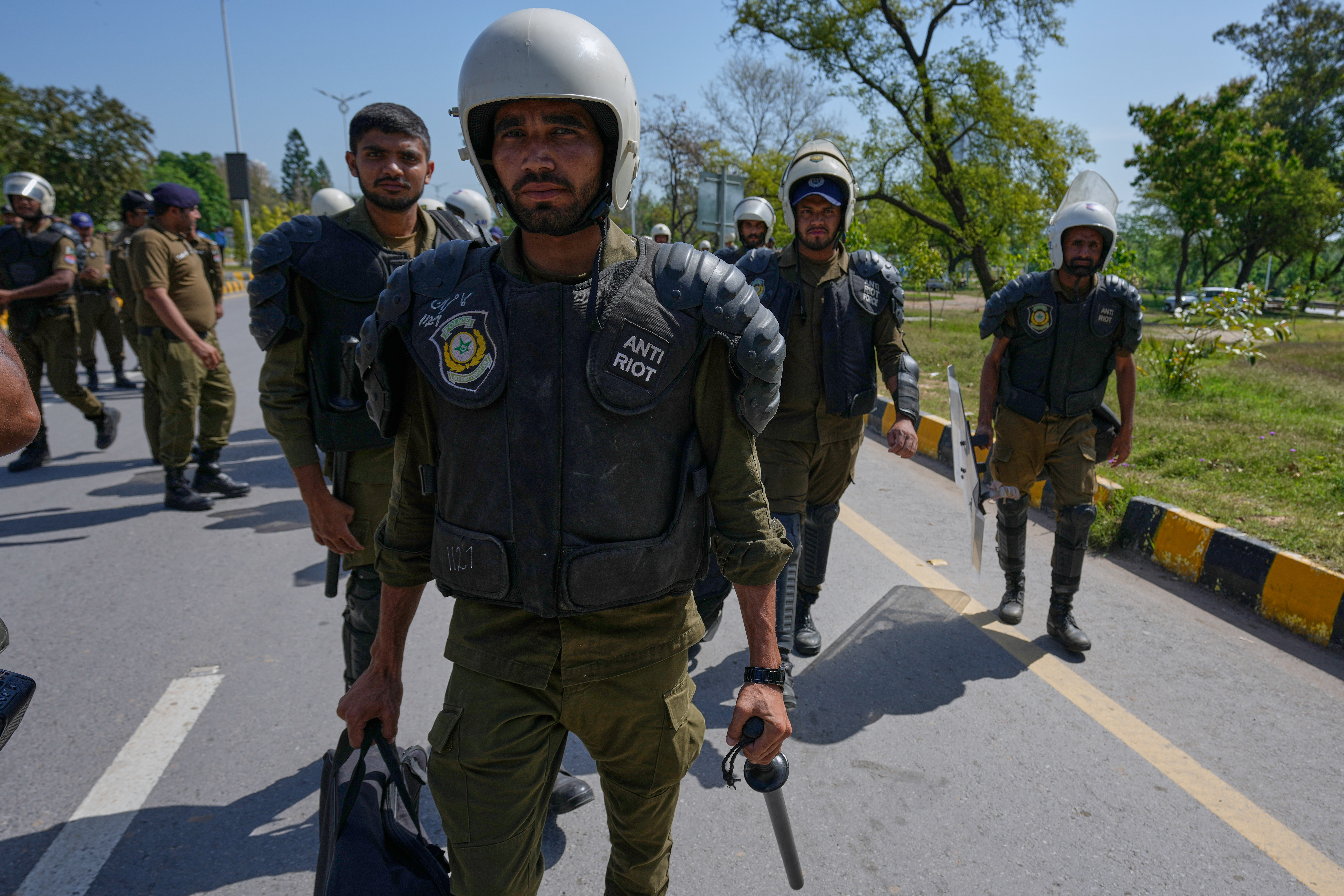 Police officers walk toward bus for their deployment in Islamabad, Pakistan, to ensure security ahead of possible negotiations between Iran and the United States, Friday, April 10, 2026. (AP Photo/Anjum Naveed)