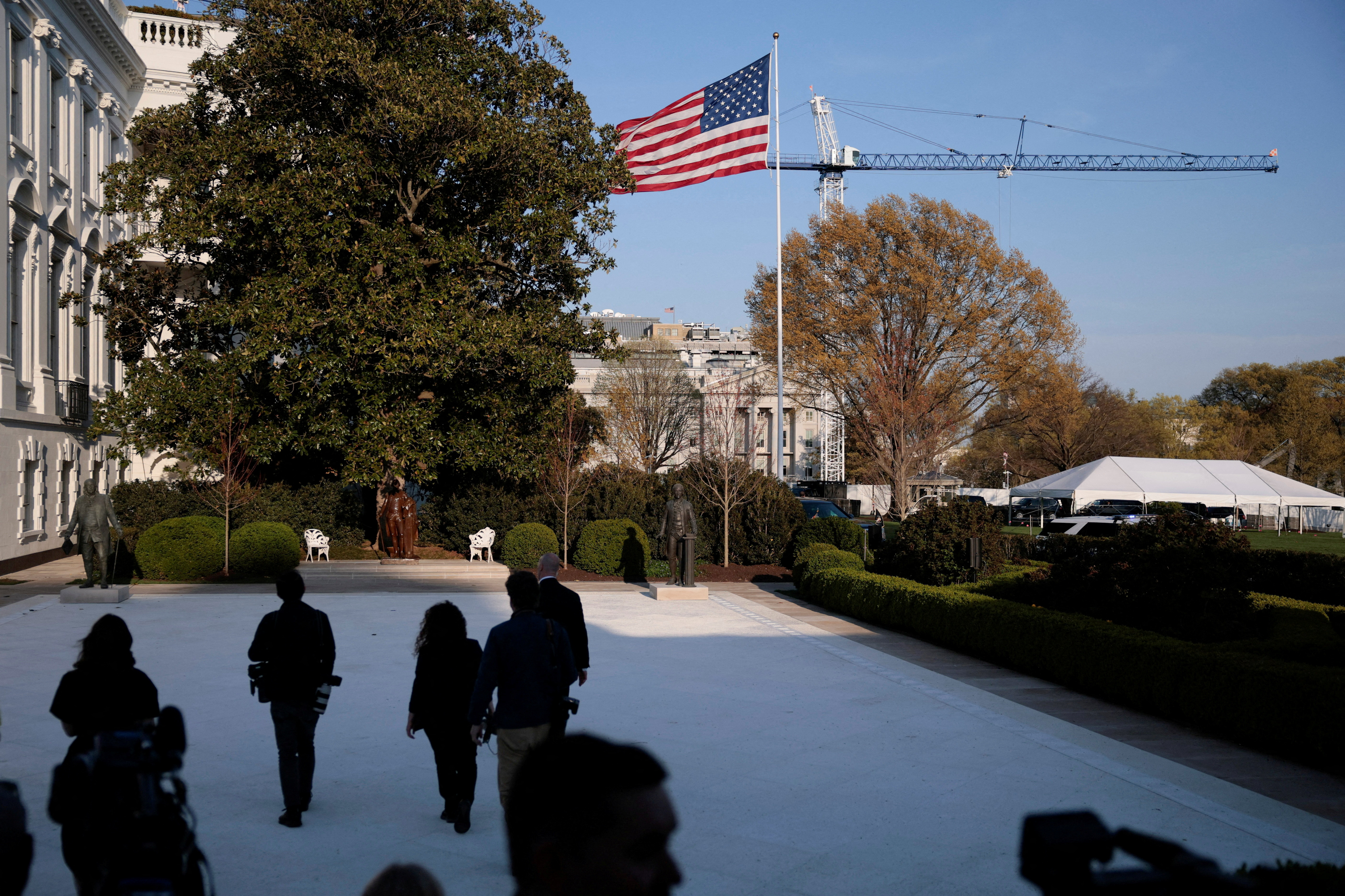 FILE PHOTO: Members of the media leave a signing ceremony for an executive order with U.S. President Donald Trump, as the cranes working on the East Wing are visible in the background after a judge said Trump cannot construct his planned ballroom without approval from Congress, in the White House in Washington, D.C., March 31, 2026. REUTERS/Evan Vucci/File Photo